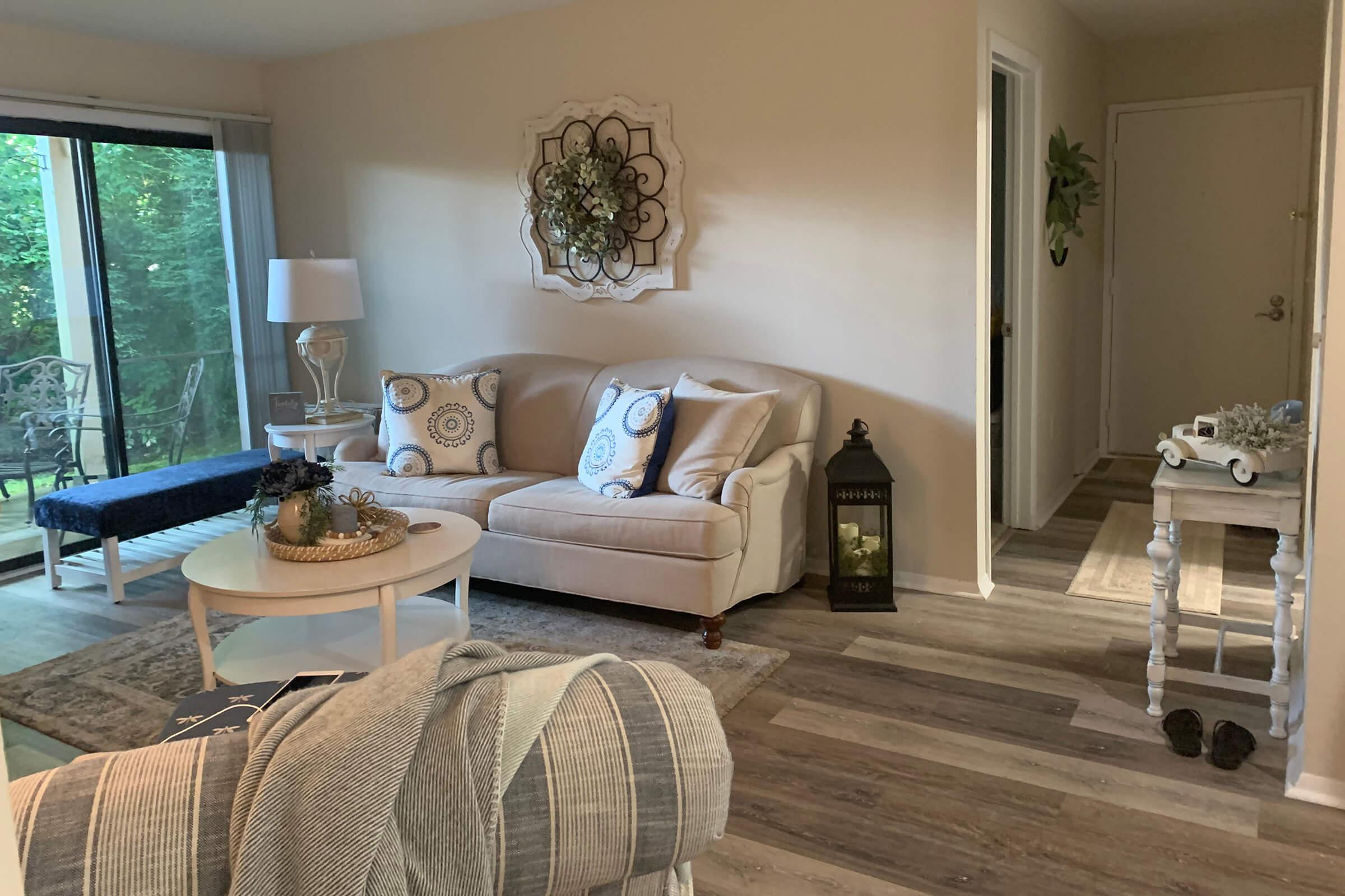 a living room filled with furniture and a large window