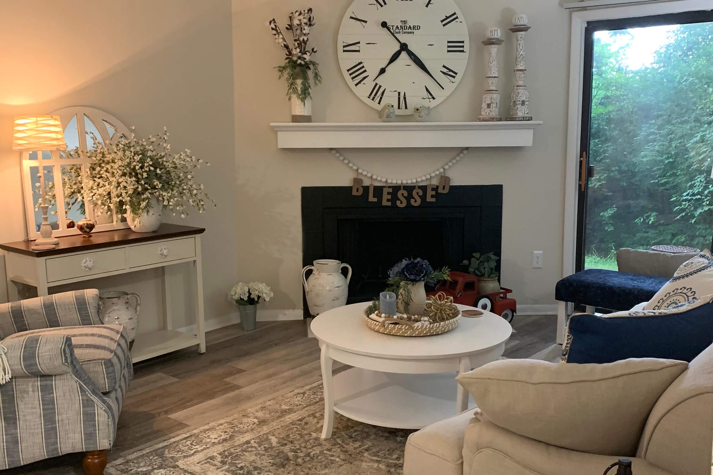 a living room filled with furniture and a clock