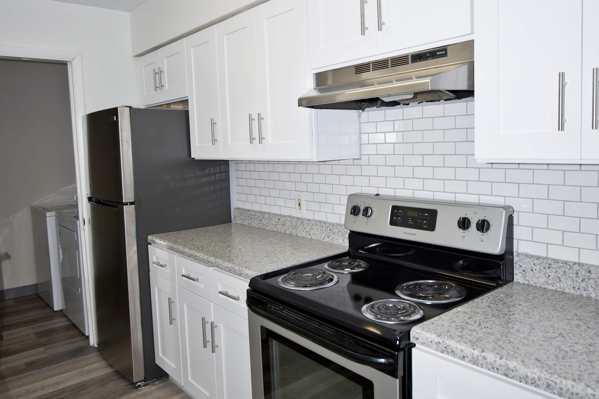 a stove top oven sitting inside of a kitchen