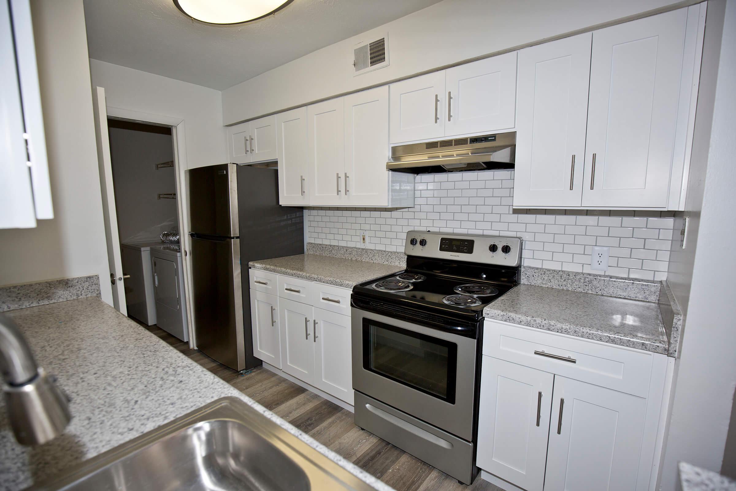 a stove top oven sitting inside of a kitchen