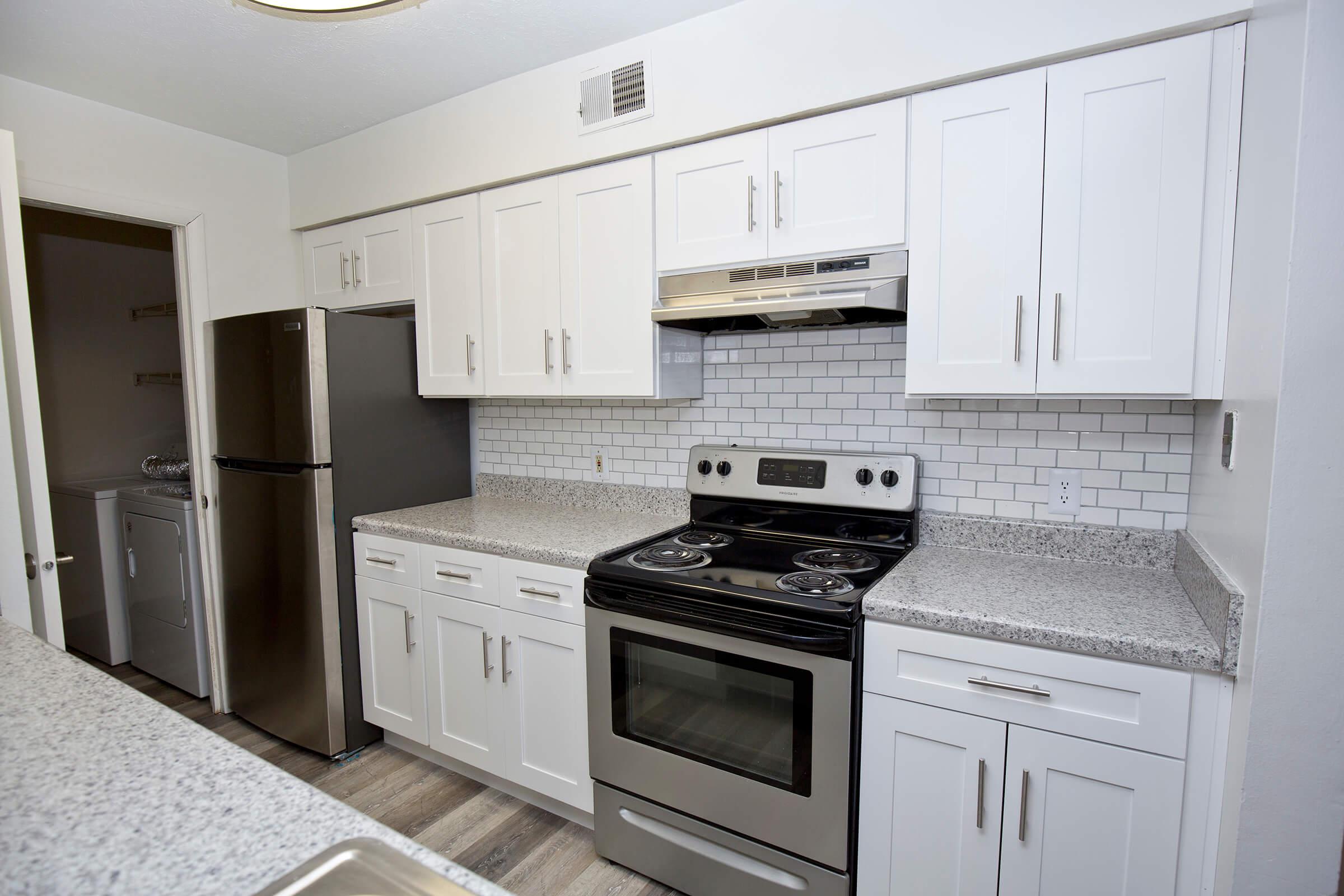 a stove top oven sitting inside of a kitchen