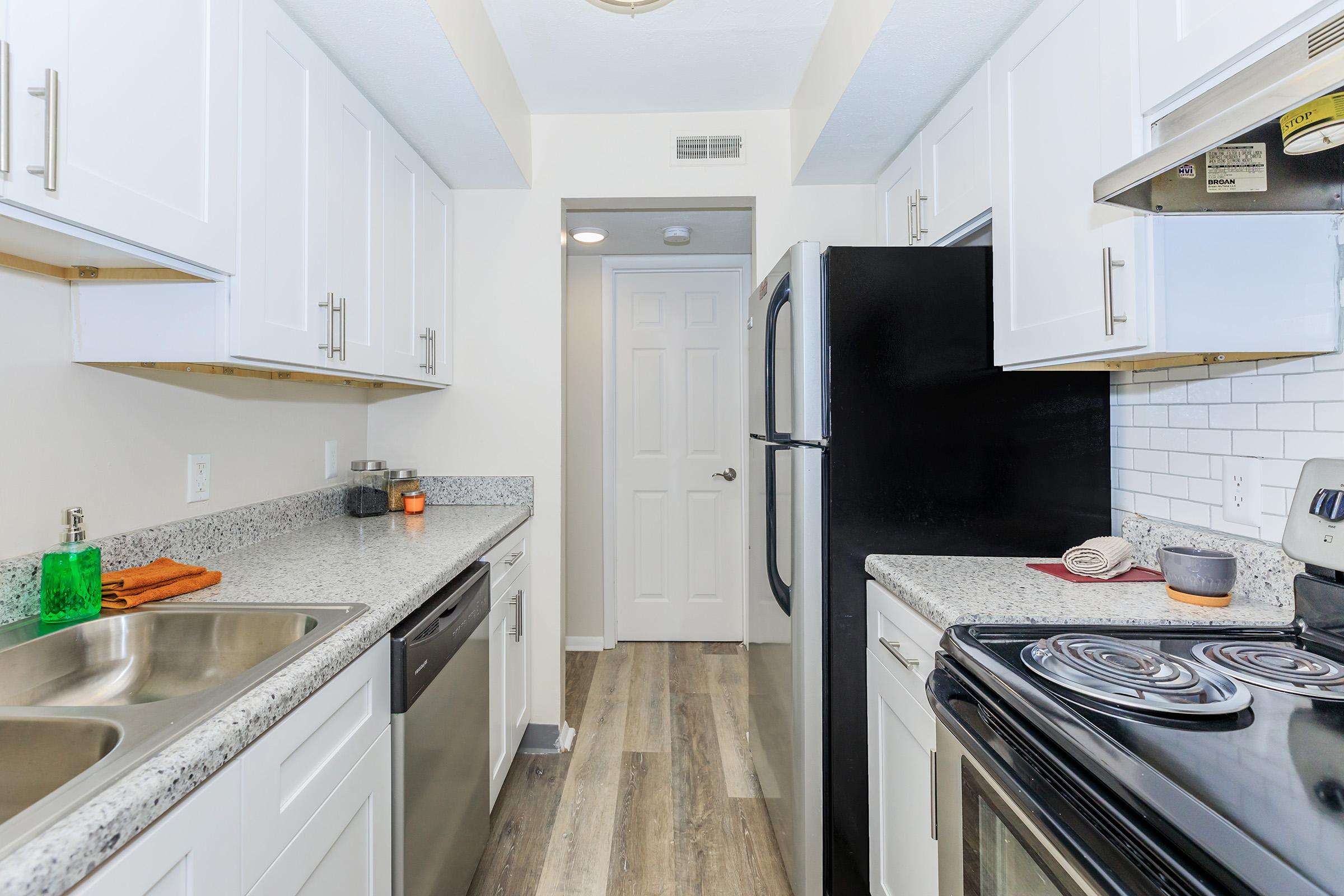 a kitchen with a stove sink and refrigerator