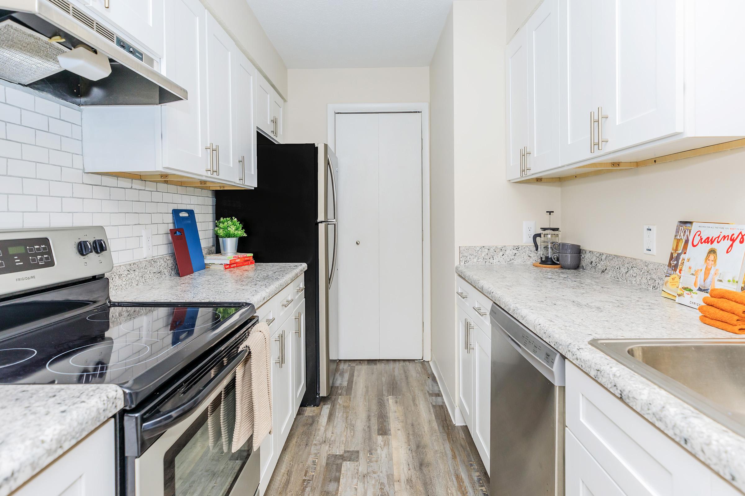 a kitchen with a stove a sink and a microwave