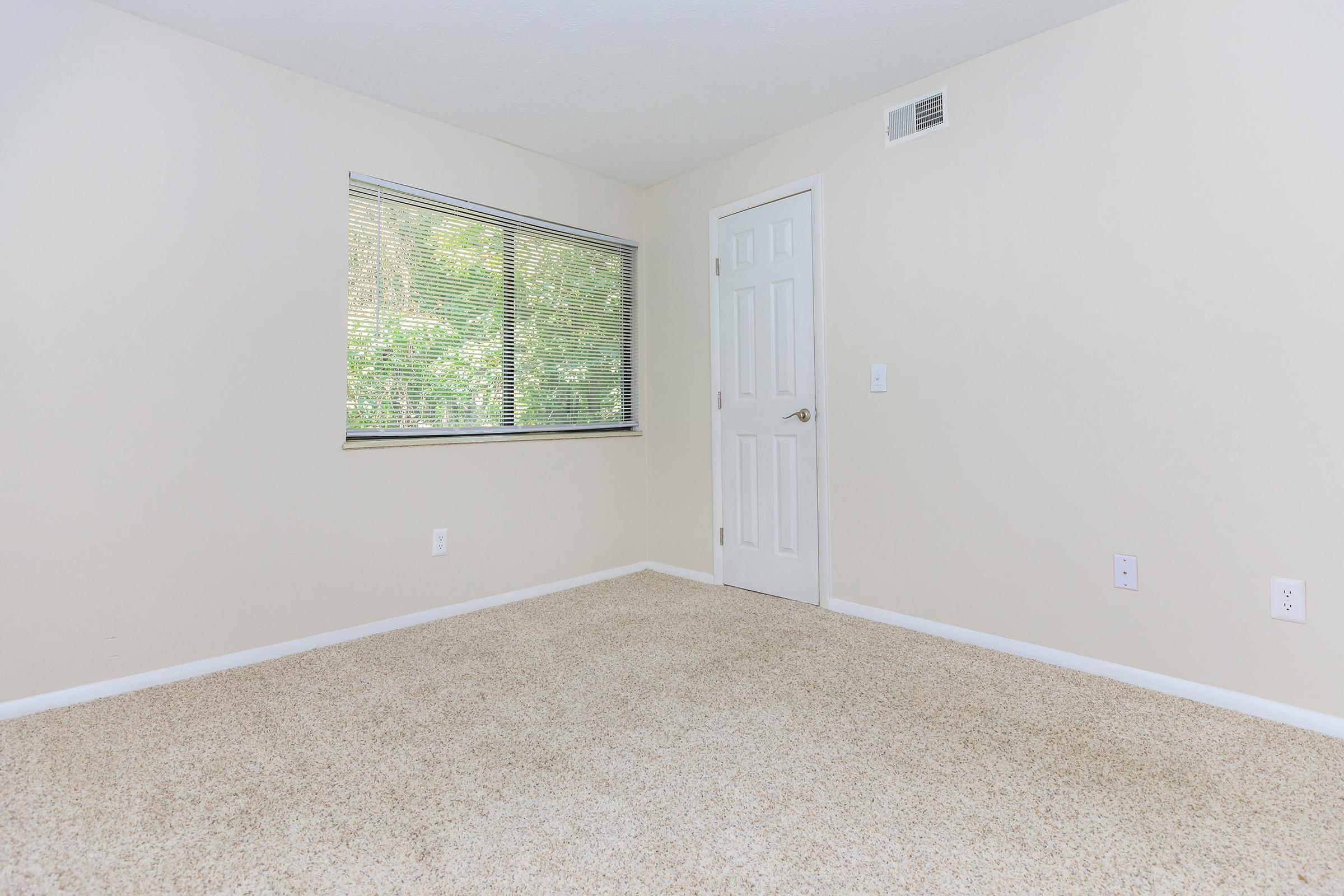 a bedroom with a large mirror