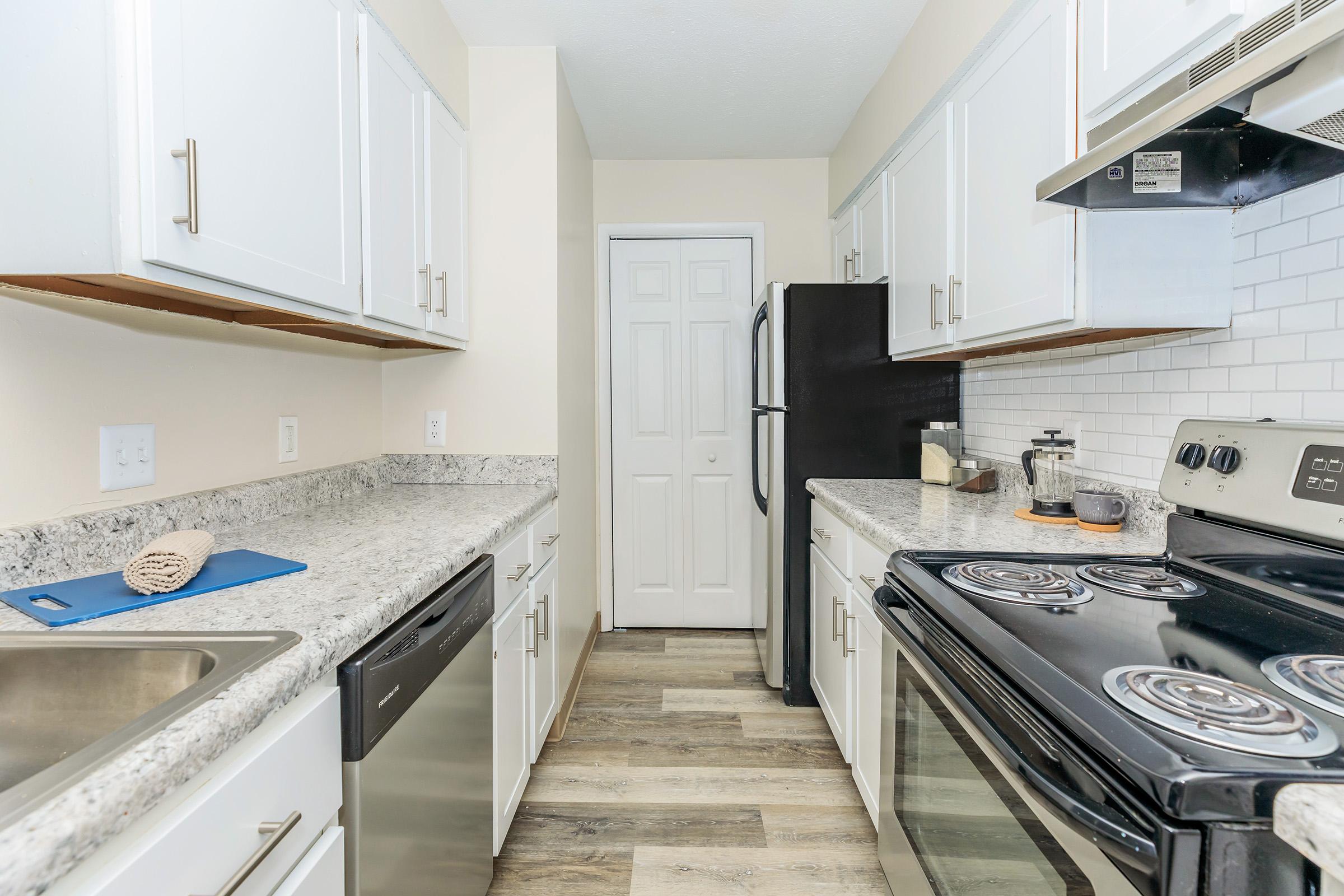 a kitchen with a sink and a stove top oven