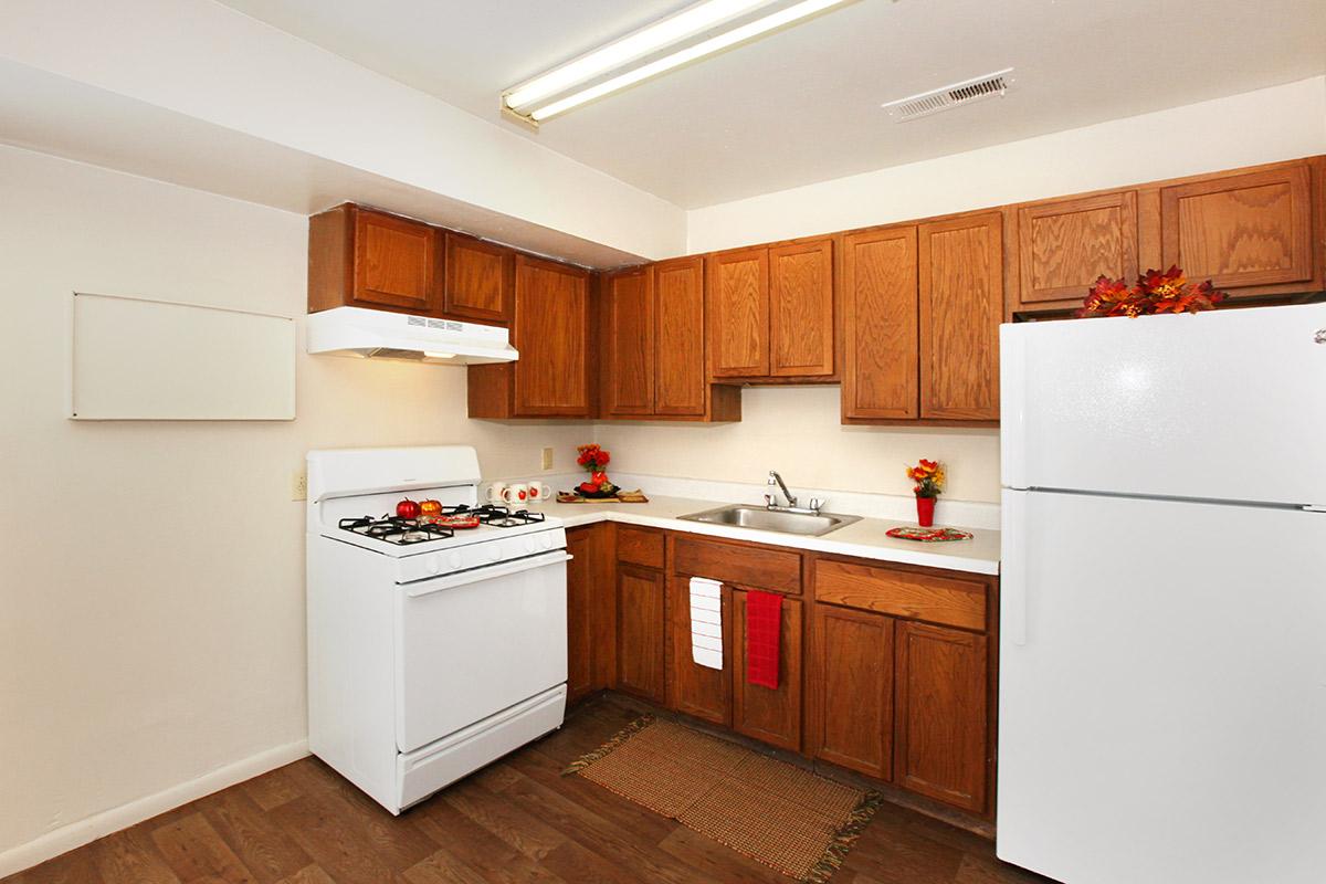 a kitchen with a stove and a refrigerator