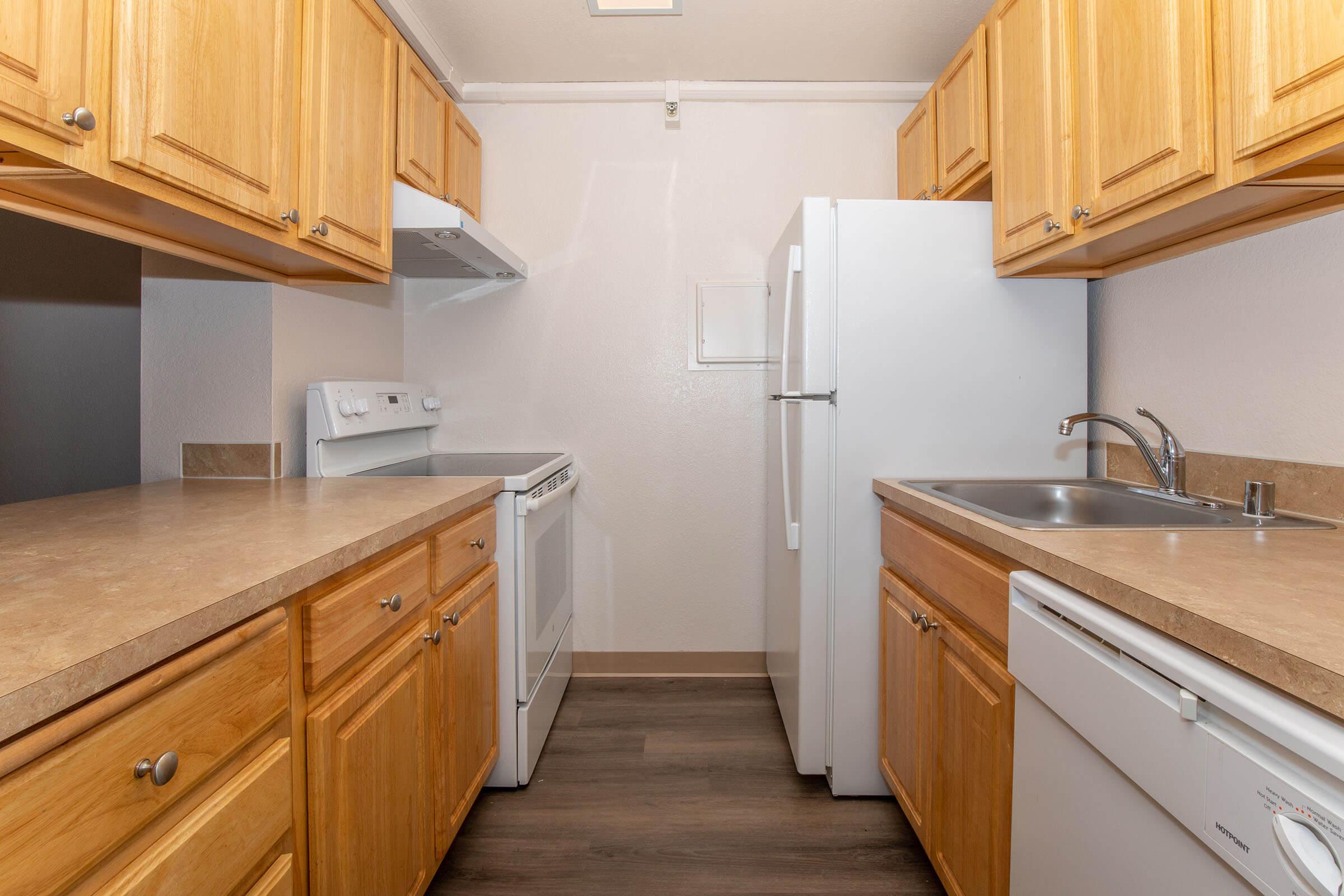 a kitchen with wooden cabinets