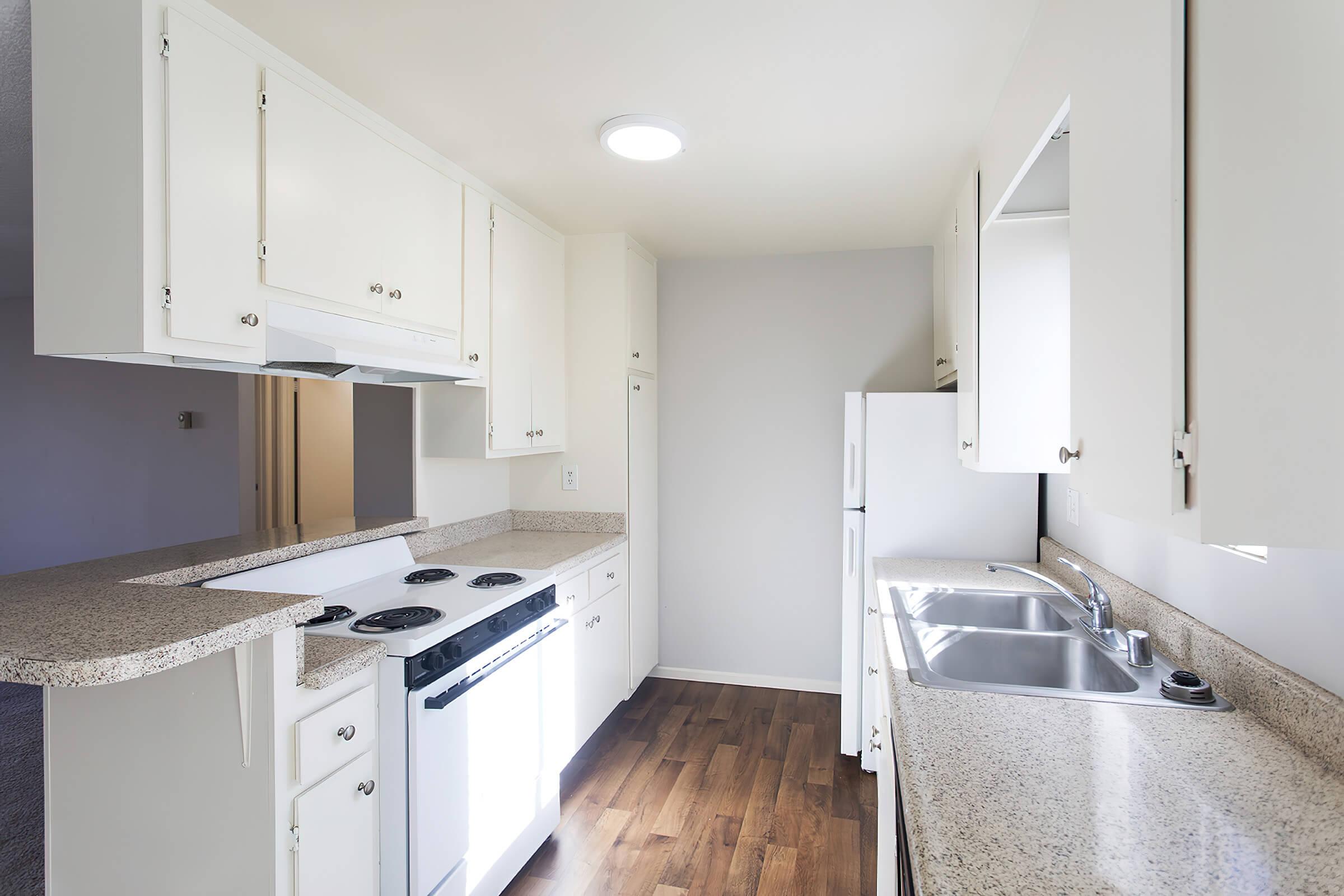 a kitchen with a sink and a mirror