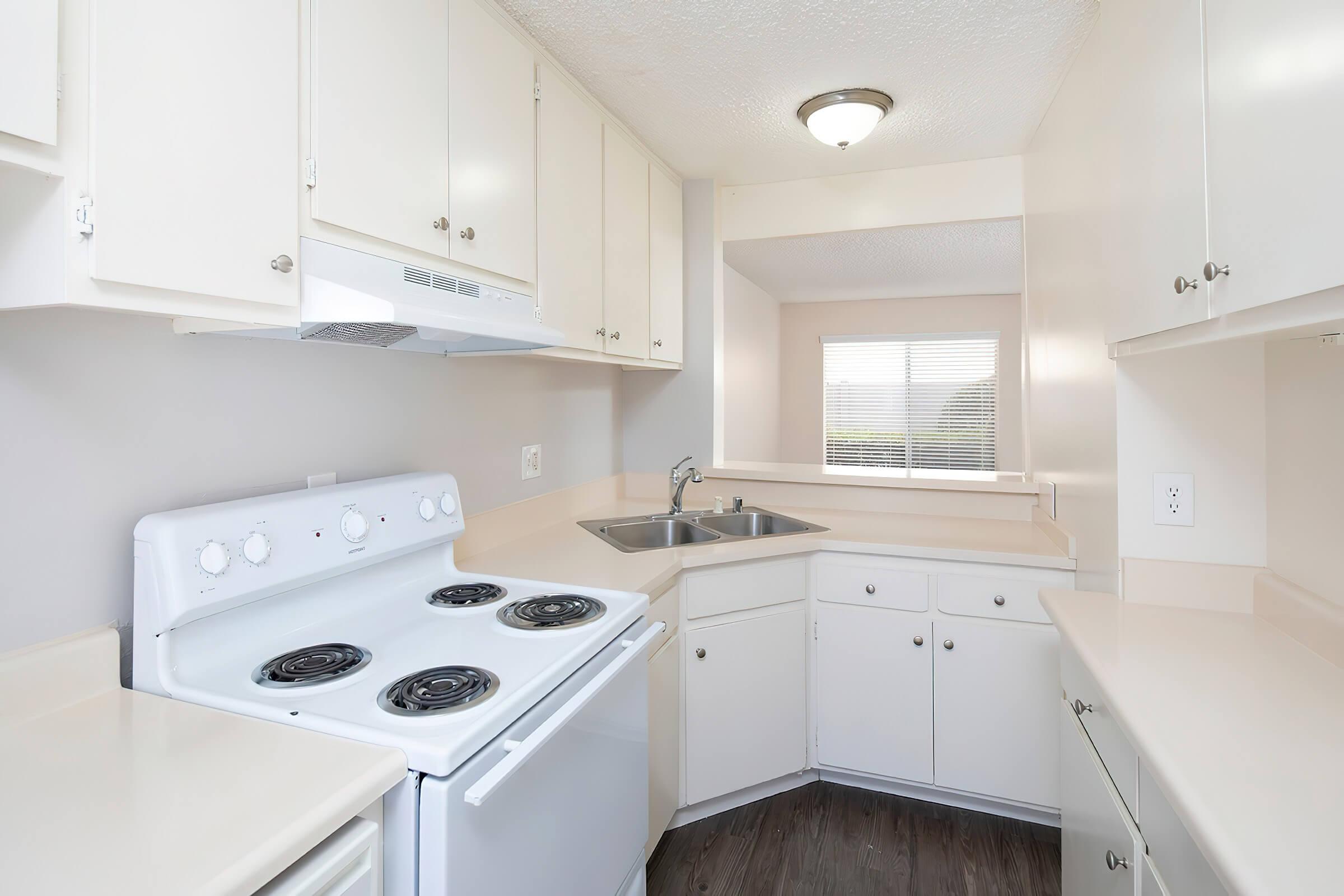 a stove top oven sitting inside of a kitchen