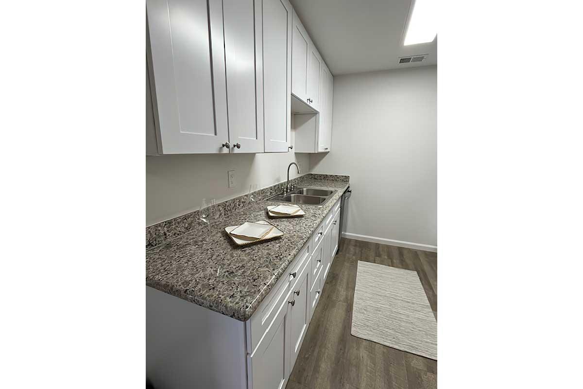 a kitchen with a sink and a mirror