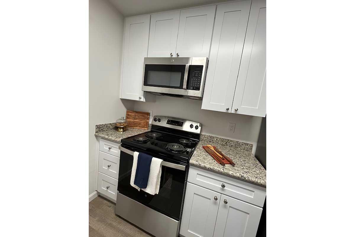 a stove top oven sitting inside of a kitchen