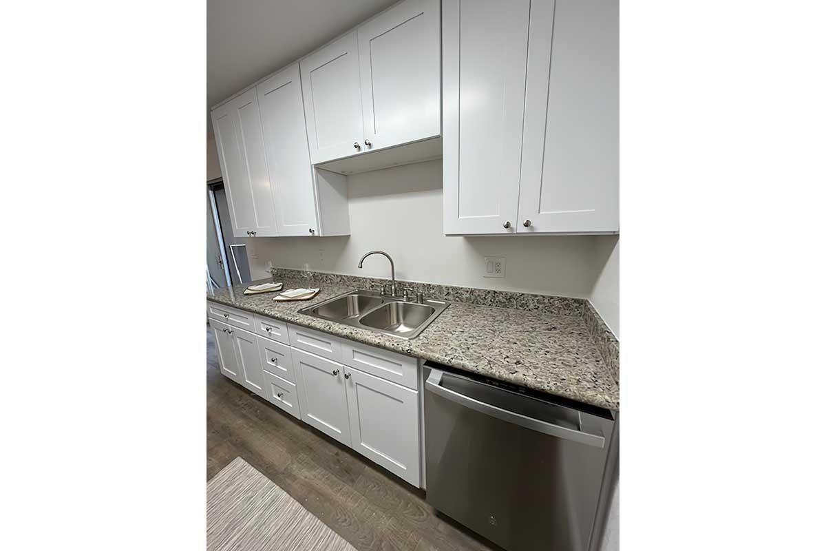 a stove top oven sitting inside of a kitchen