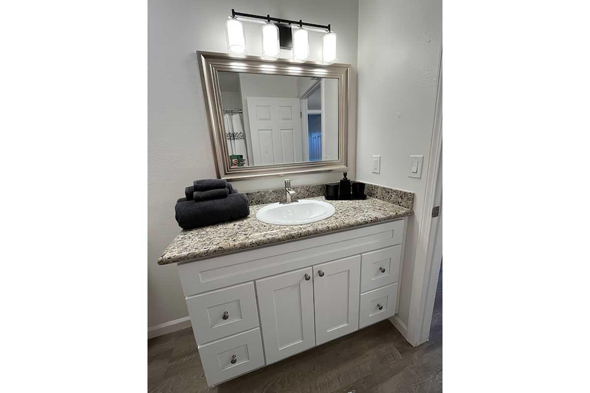 a kitchen with a sink and a mirror