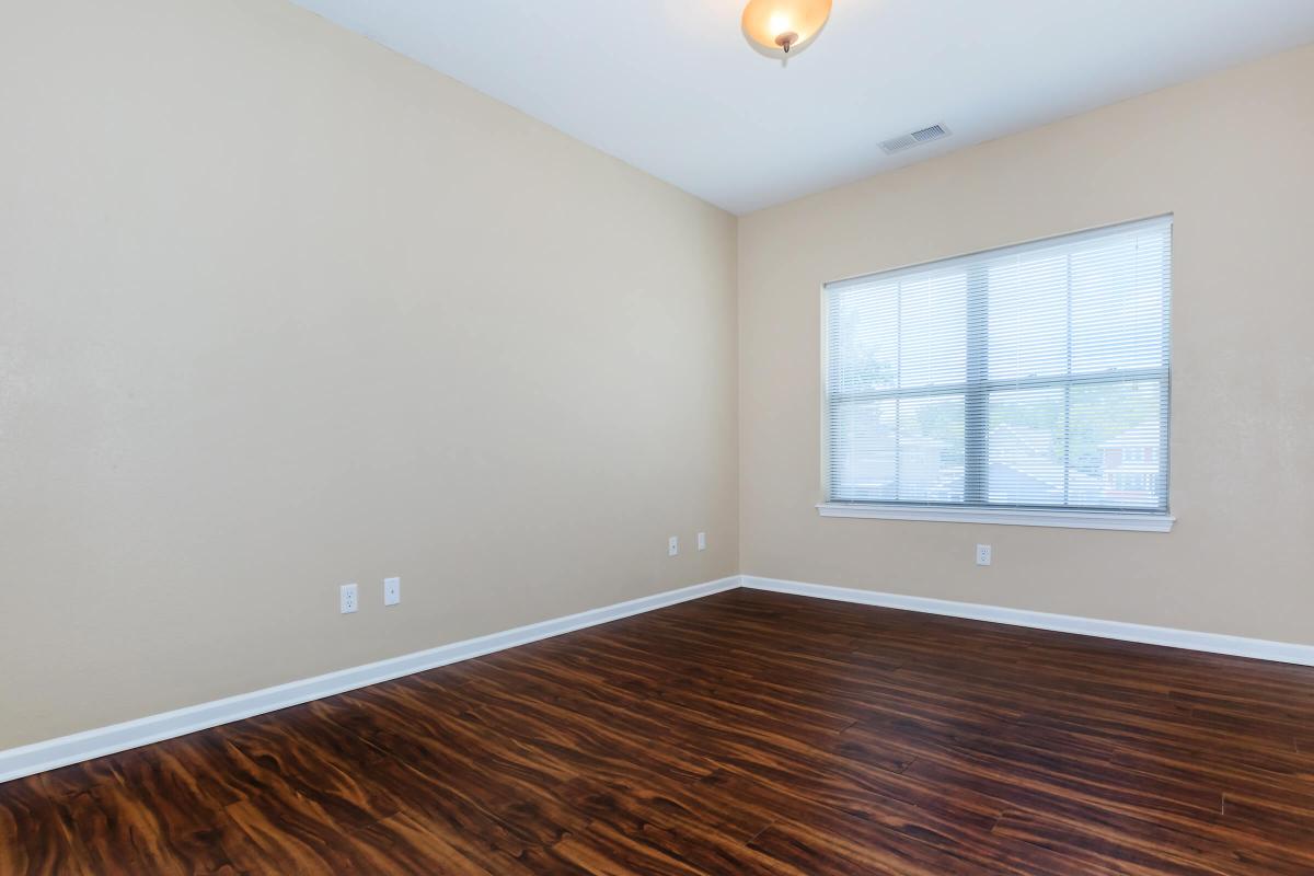 a close up of a hard wood floor next to a window