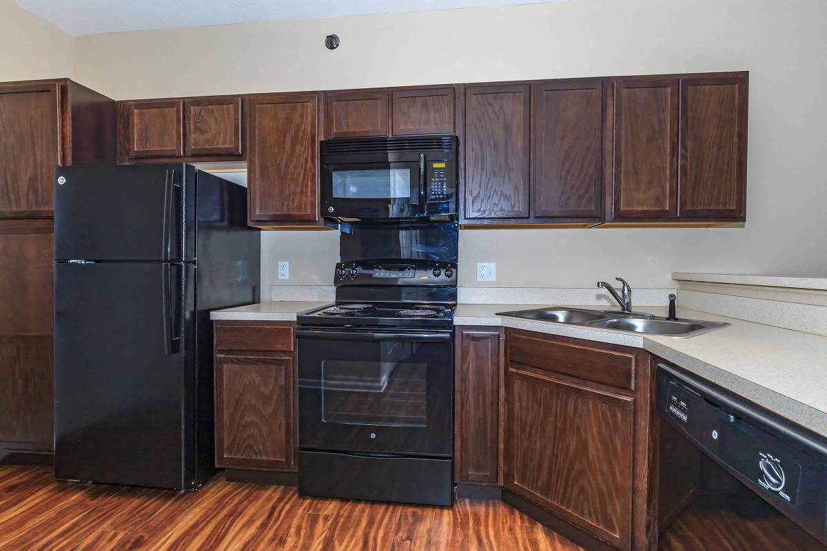 a kitchen with stainless steel appliances and wooden cabinets