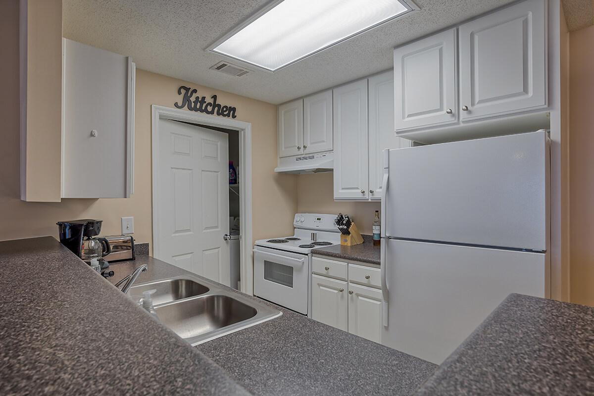 a kitchen with a sink and a refrigerator