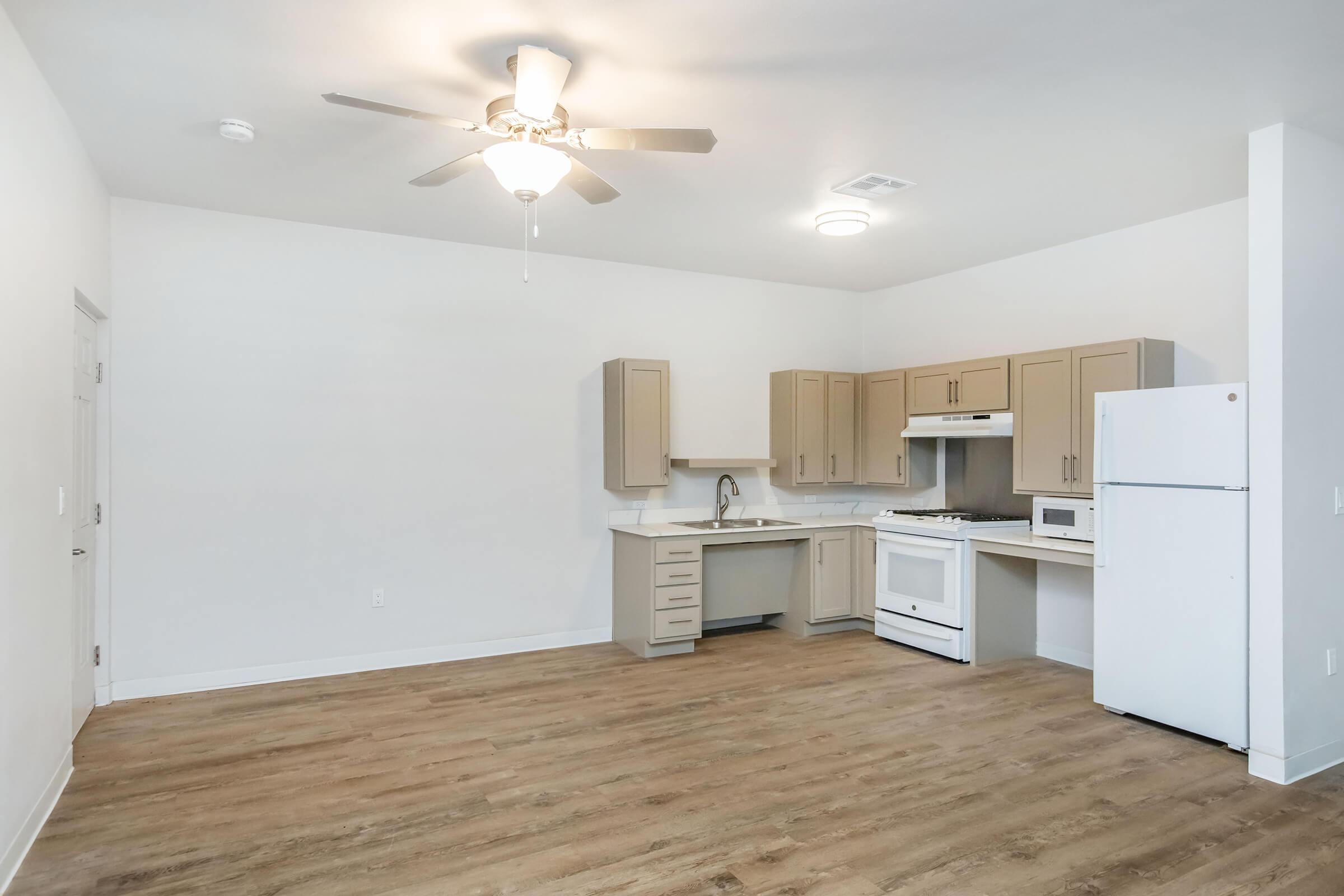 a kitchen with a refrigerator in a room