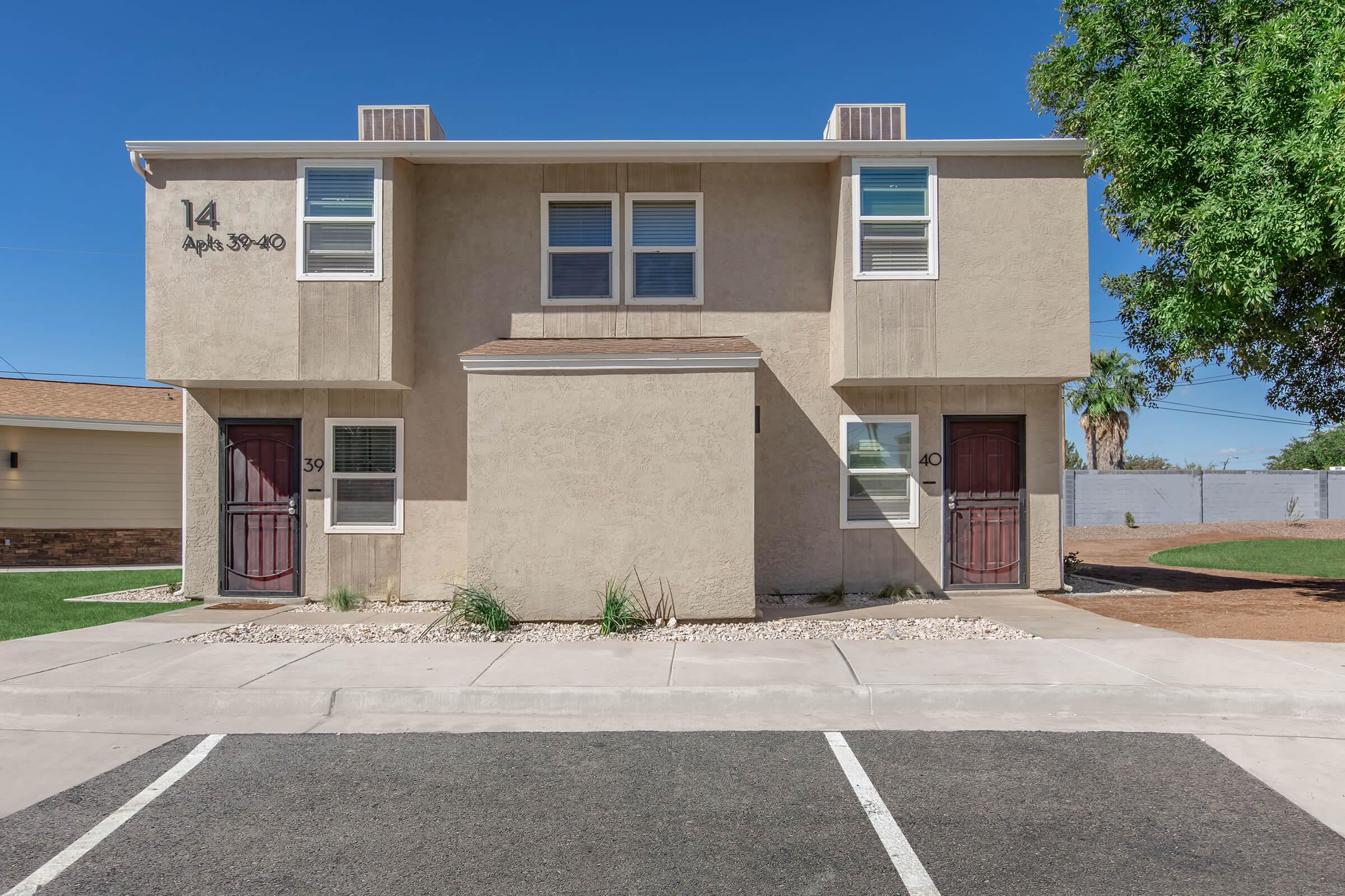 an empty parking lot in front of a house