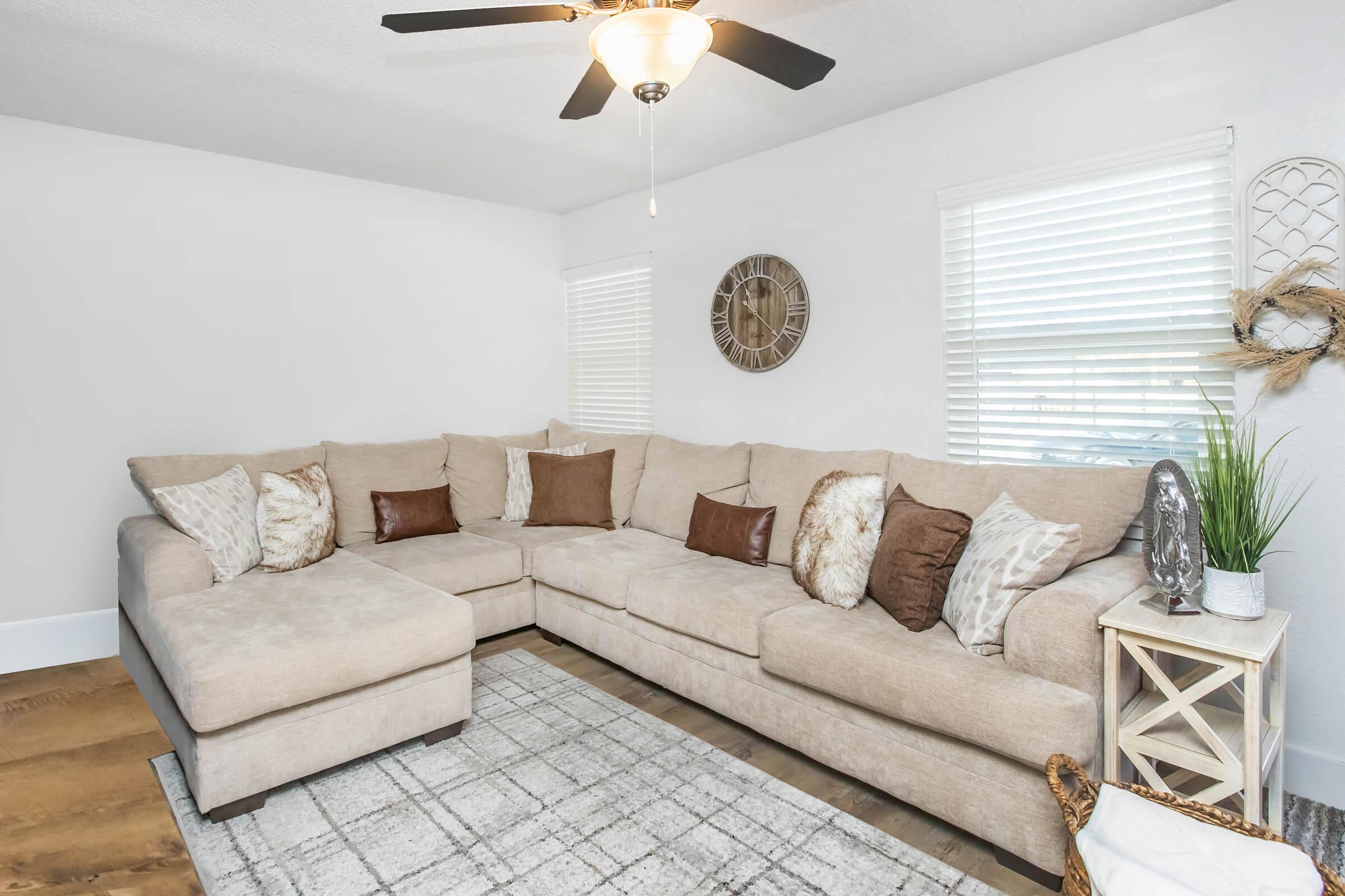 a living room filled with furniture and a large window