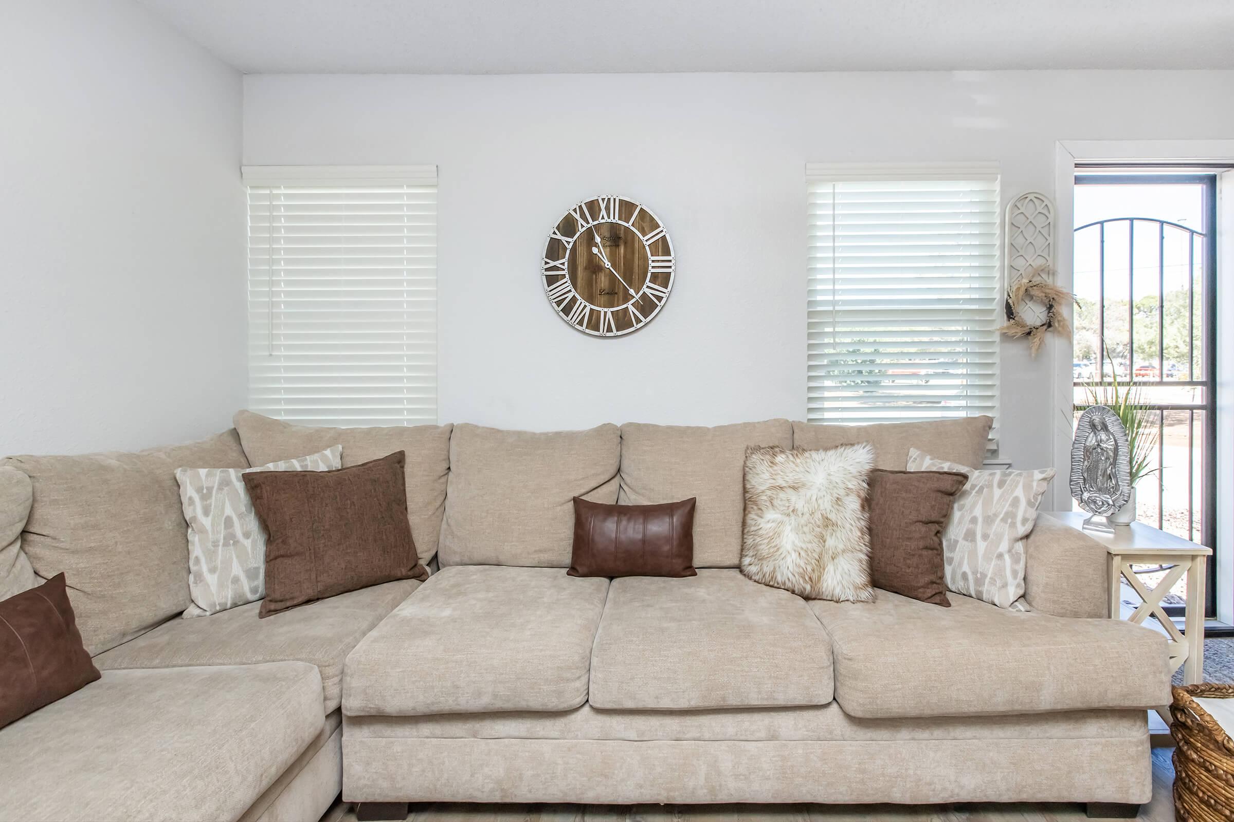 a living room filled with furniture and a large window