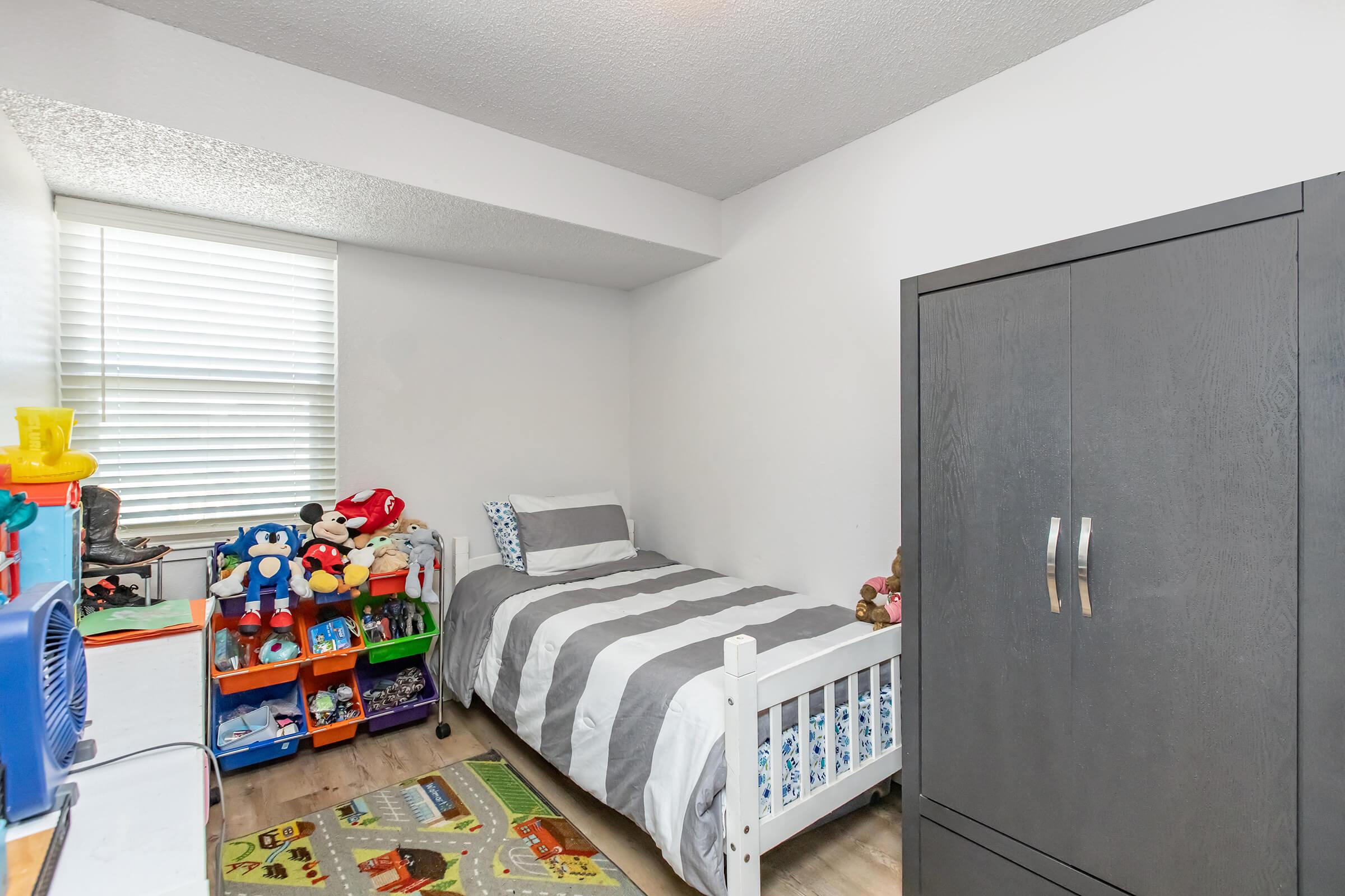 a refrigerator freezer sitting in a bedroom