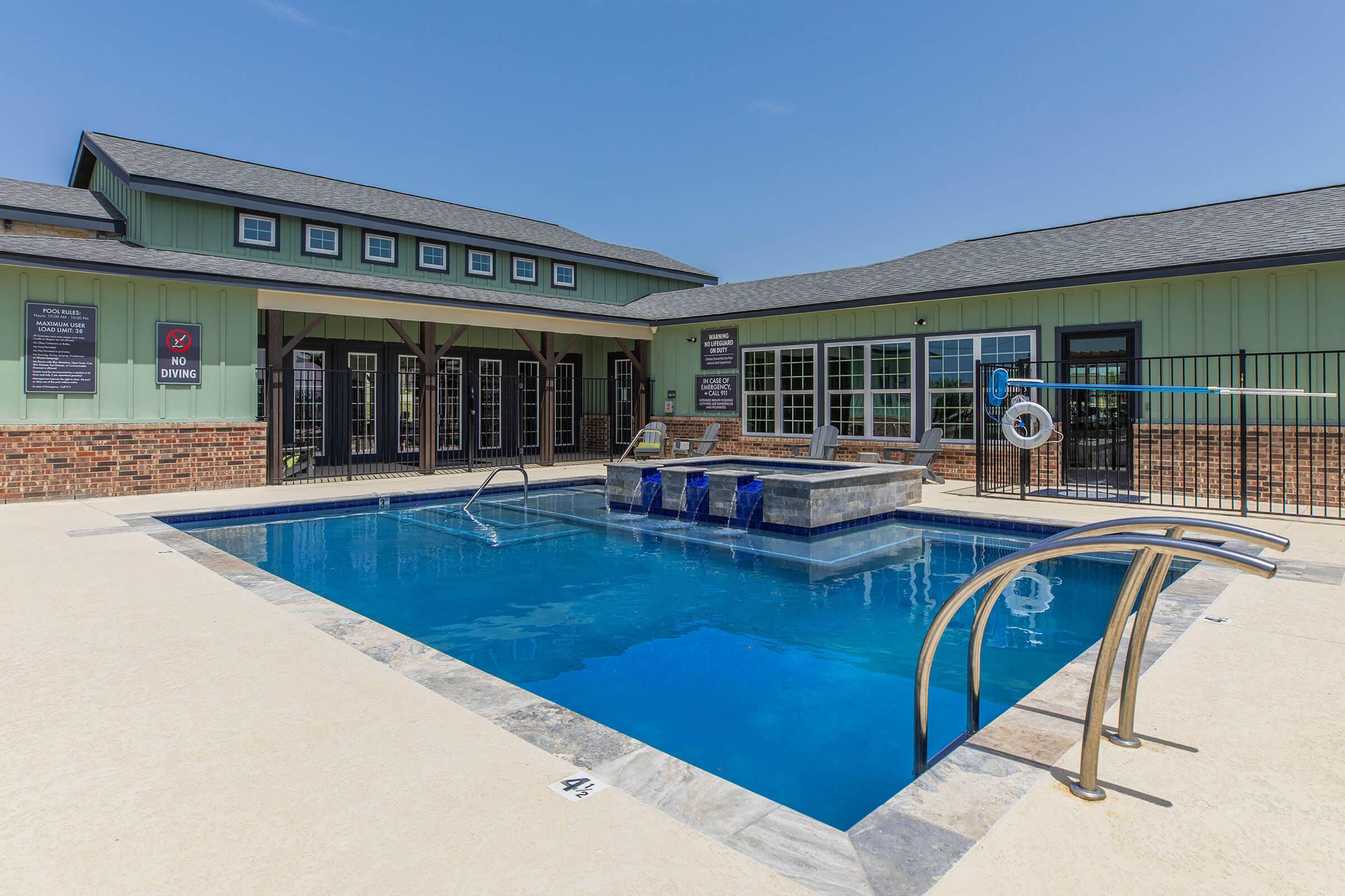 a blue pool of water in front of a house