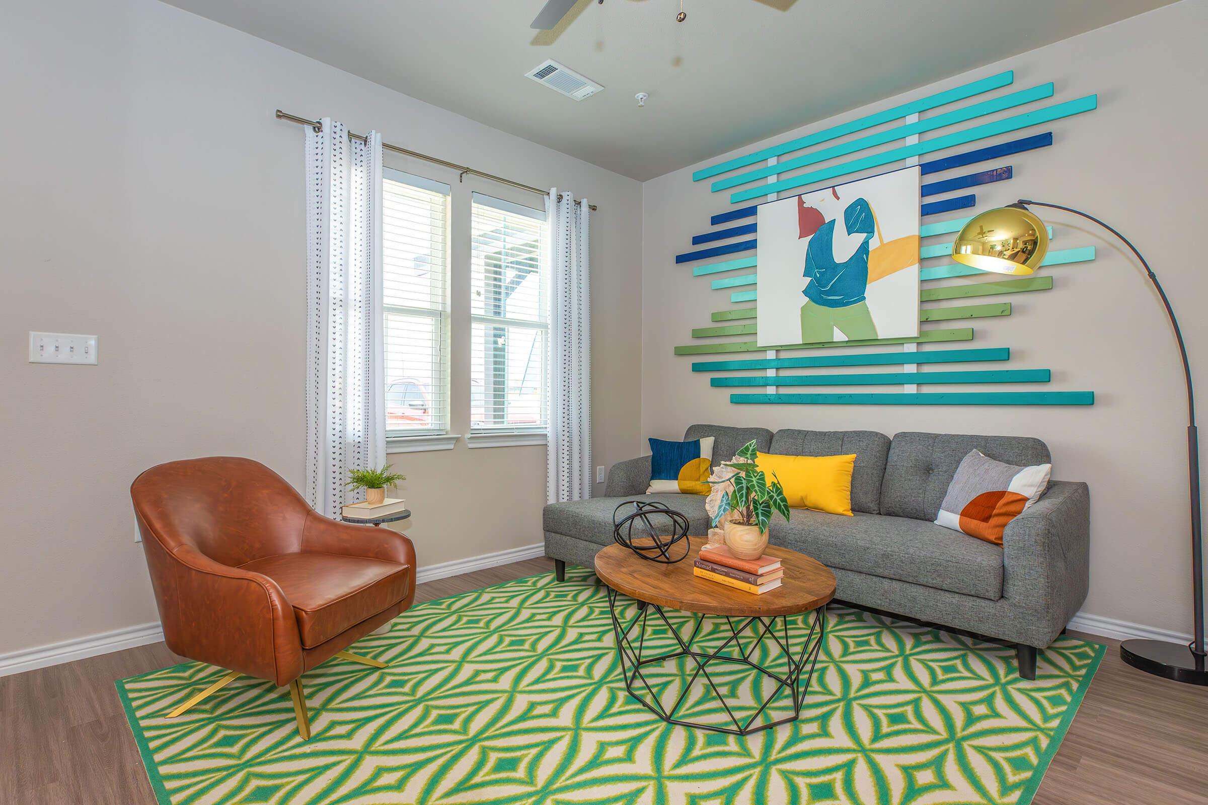 a living room filled with furniture and a large window