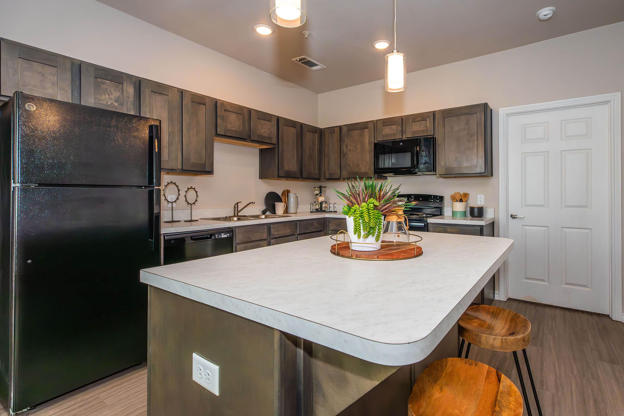 a kitchen with an island in the middle of a room