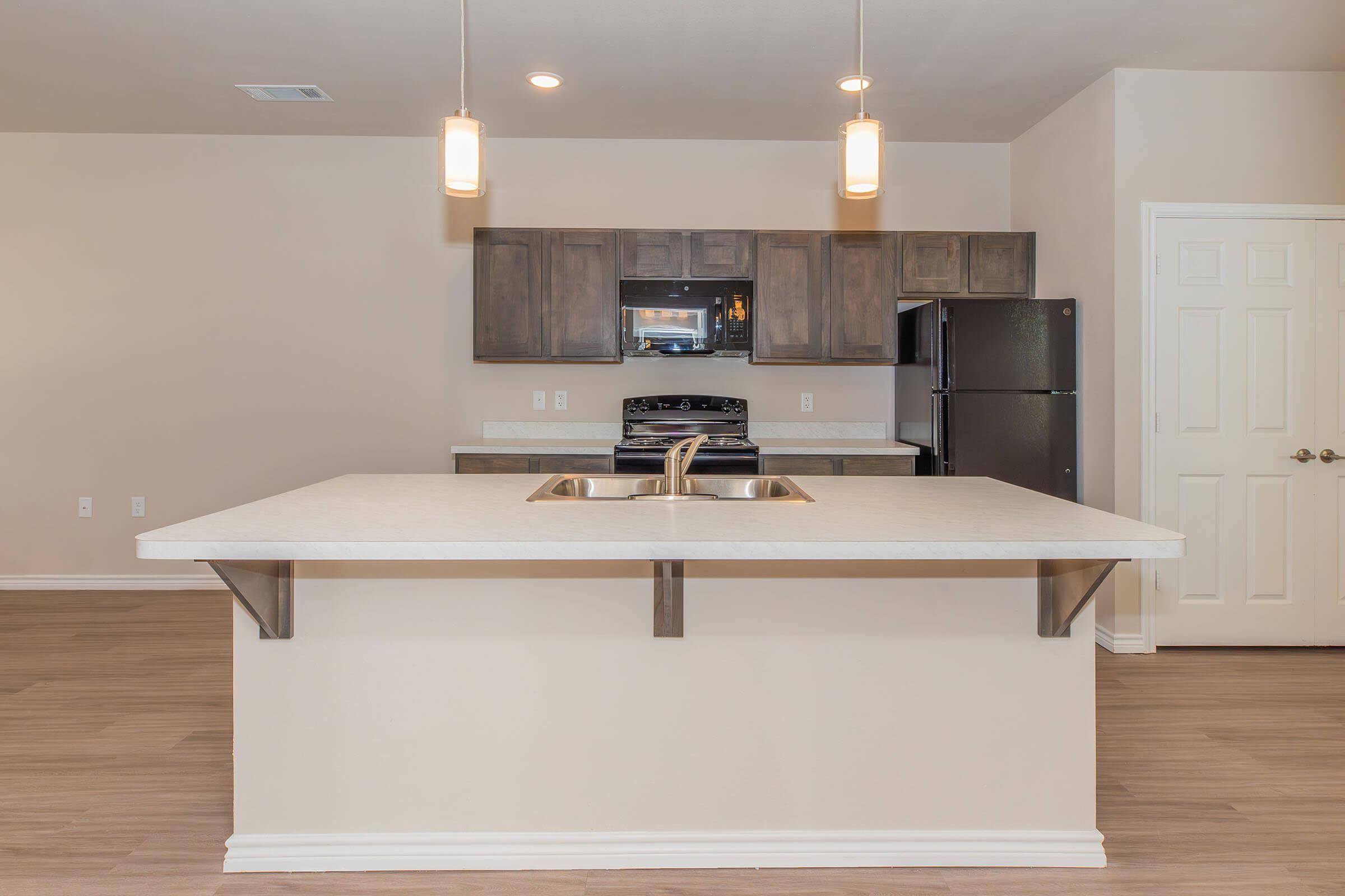 a stove top oven sitting inside of a kitchen