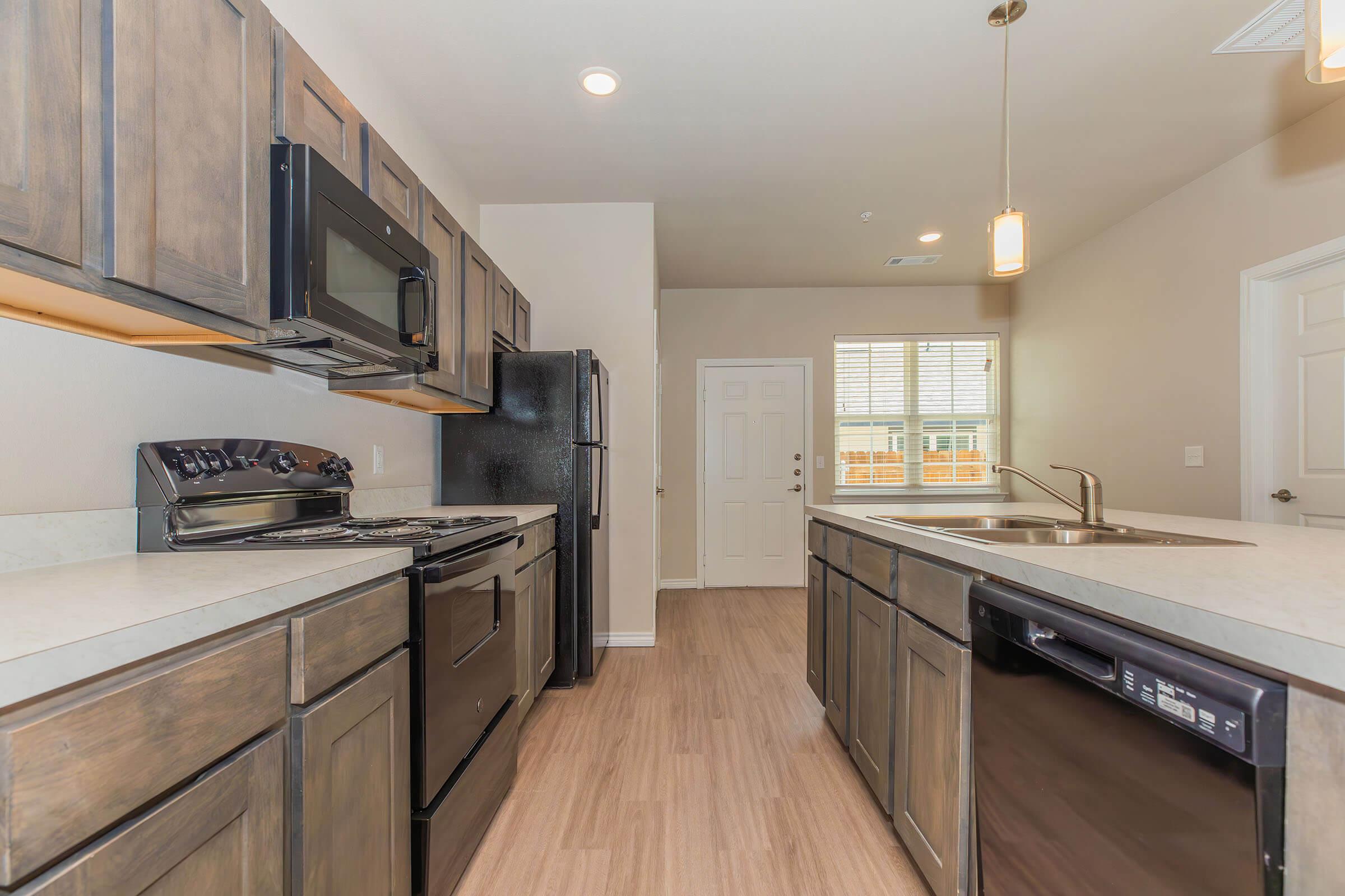 a kitchen with stainless steel appliances and wooden cabinets