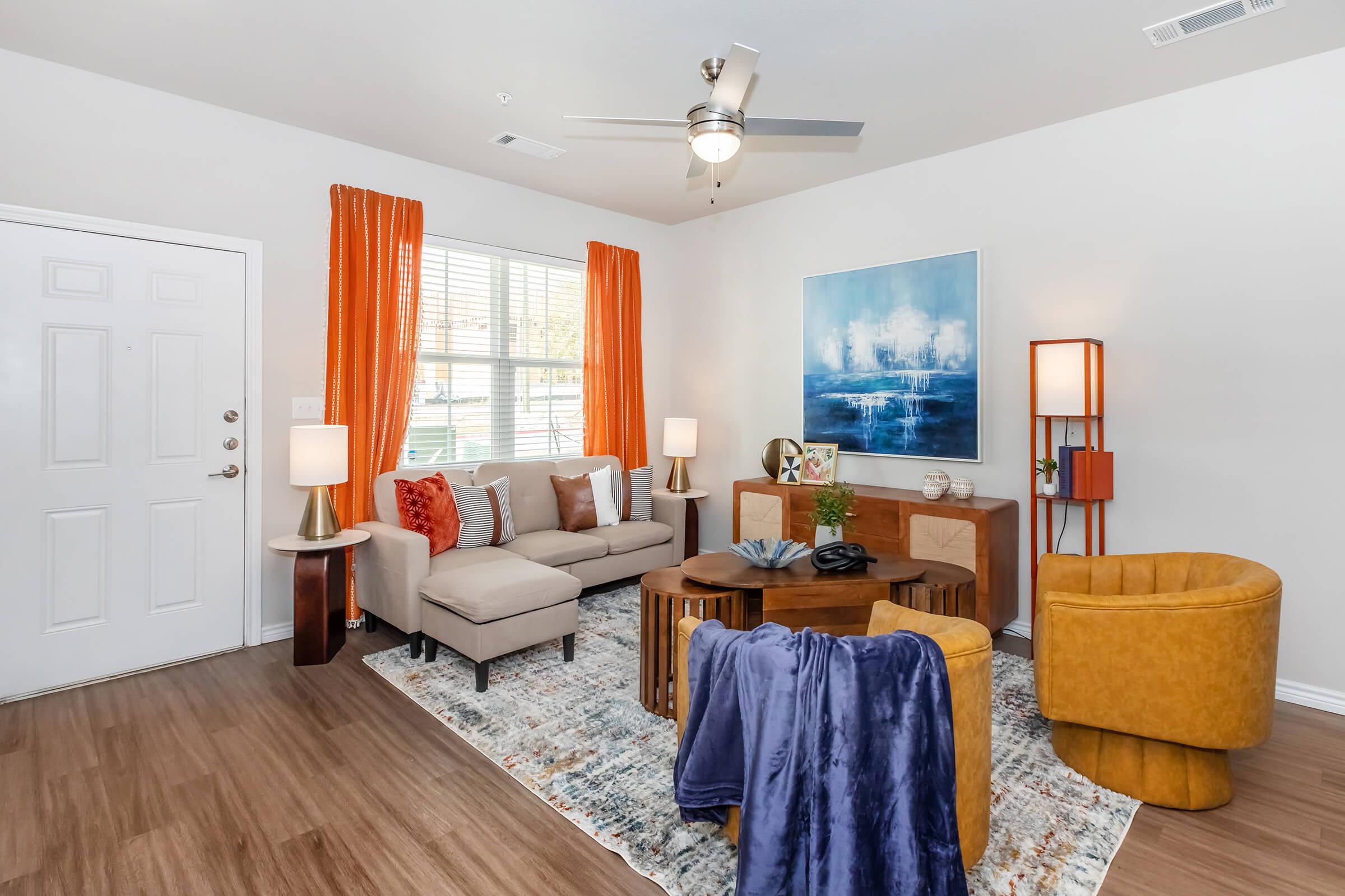 a living room filled with furniture and a flat screen tv