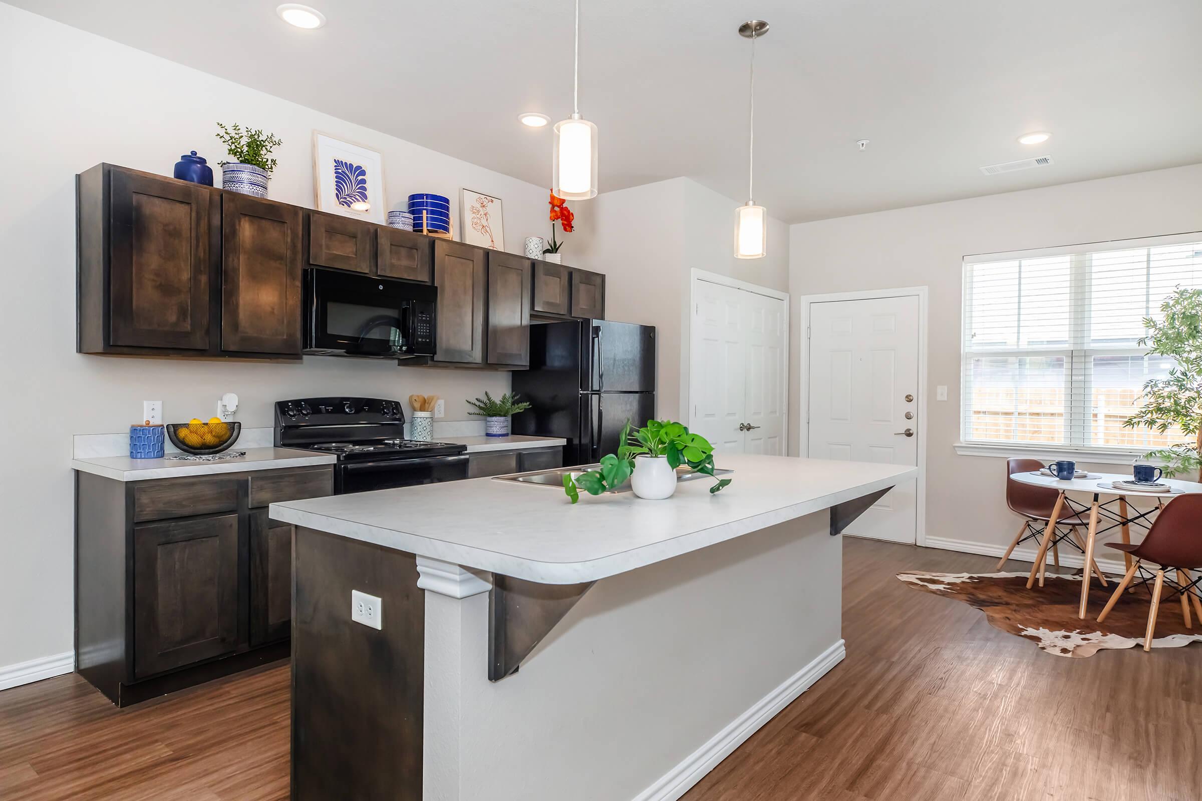 a modern kitchen with an island in the middle of a room