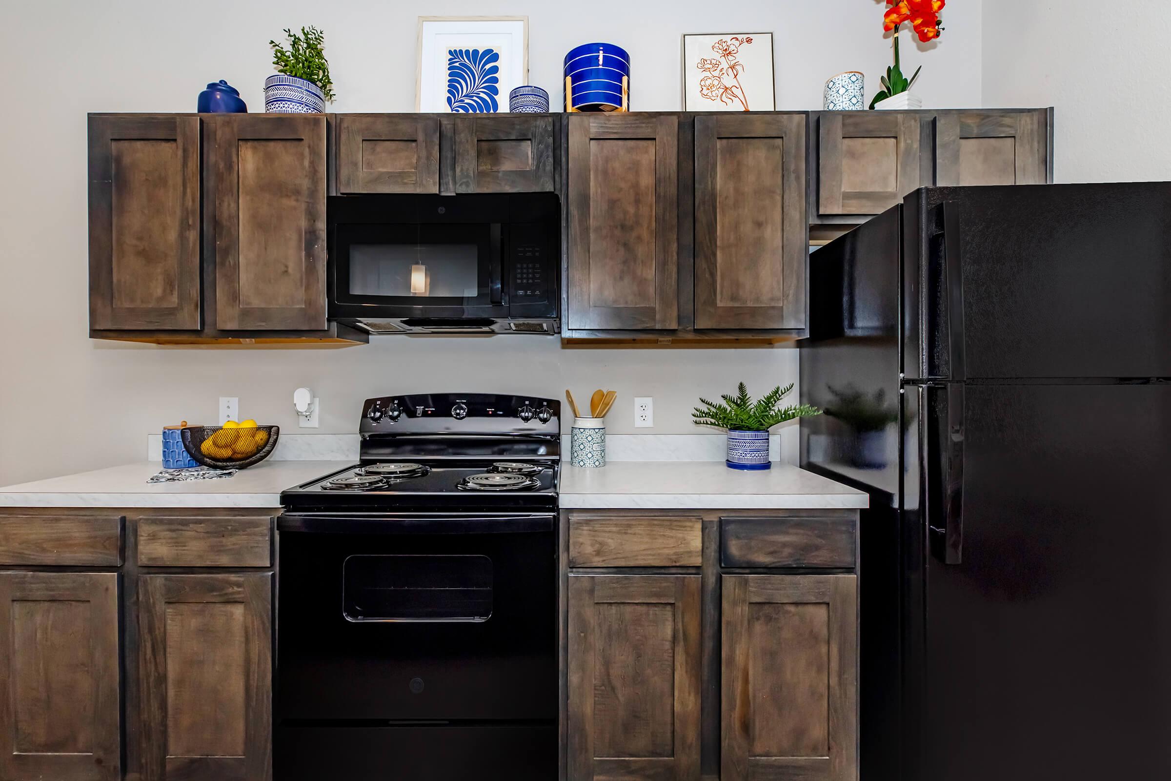 a kitchen with stainless steel appliances and wooden cabinets