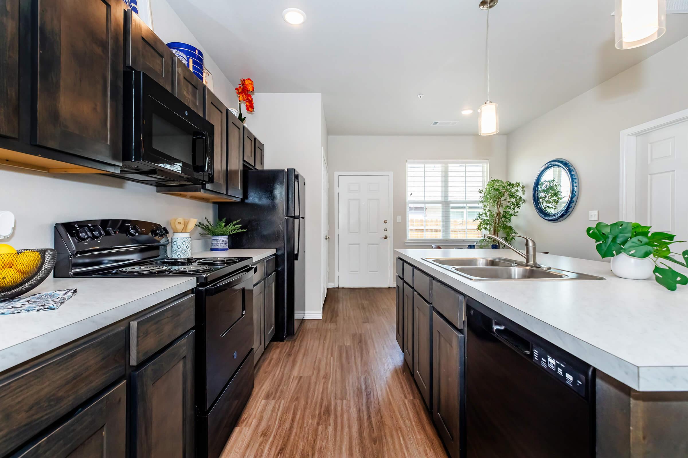 a modern kitchen with stainless steel appliances and wooden cabinets