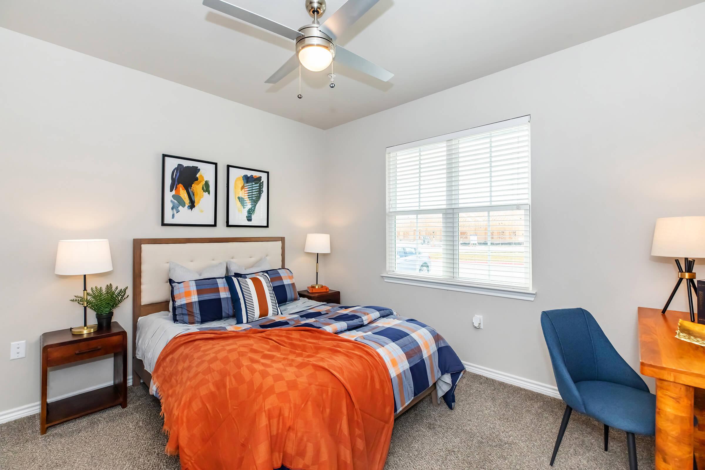 a bedroom with a bed and desk in a room