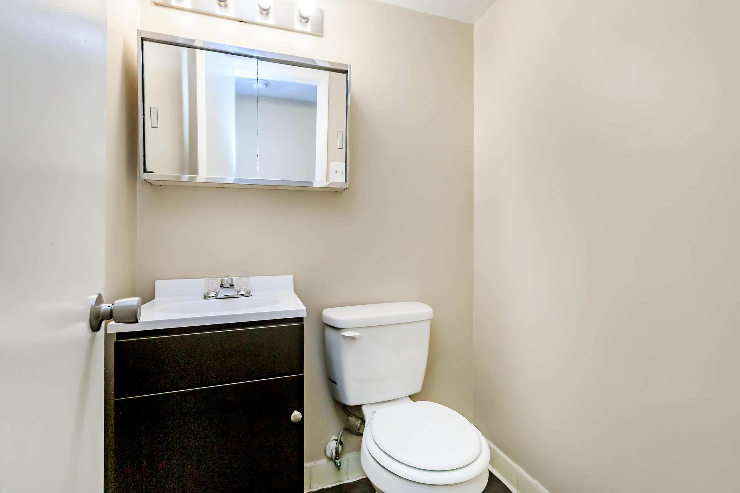 a room with a sink and a mirror