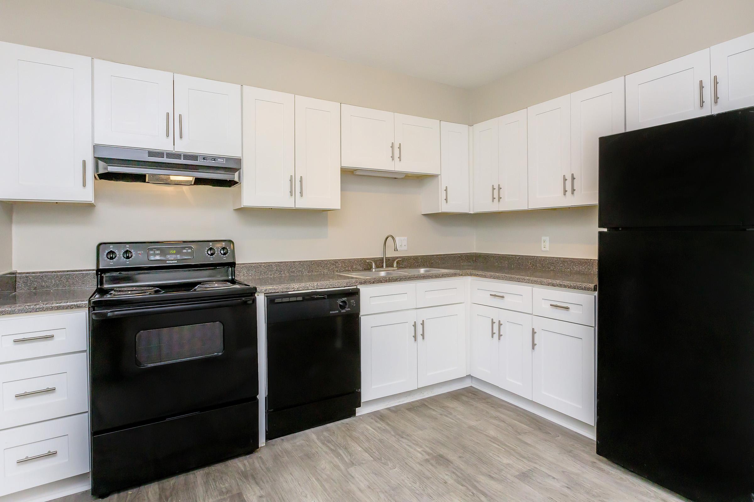 a kitchen with a stove and a refrigerator