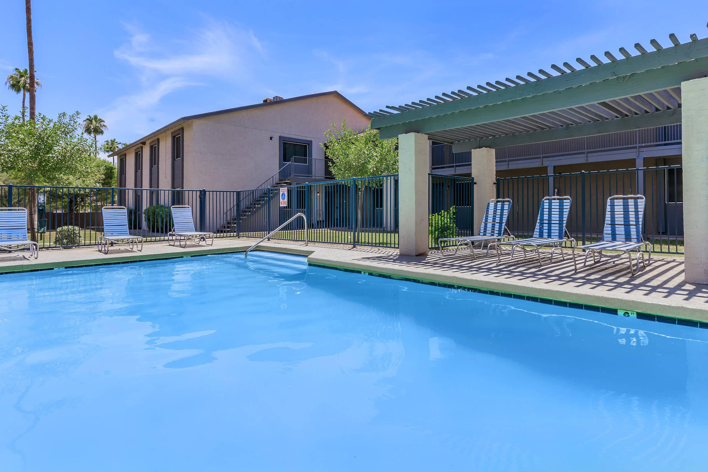 Large sparkling resort-style pool surrounded by deck chairs at Rise on Cave Creek