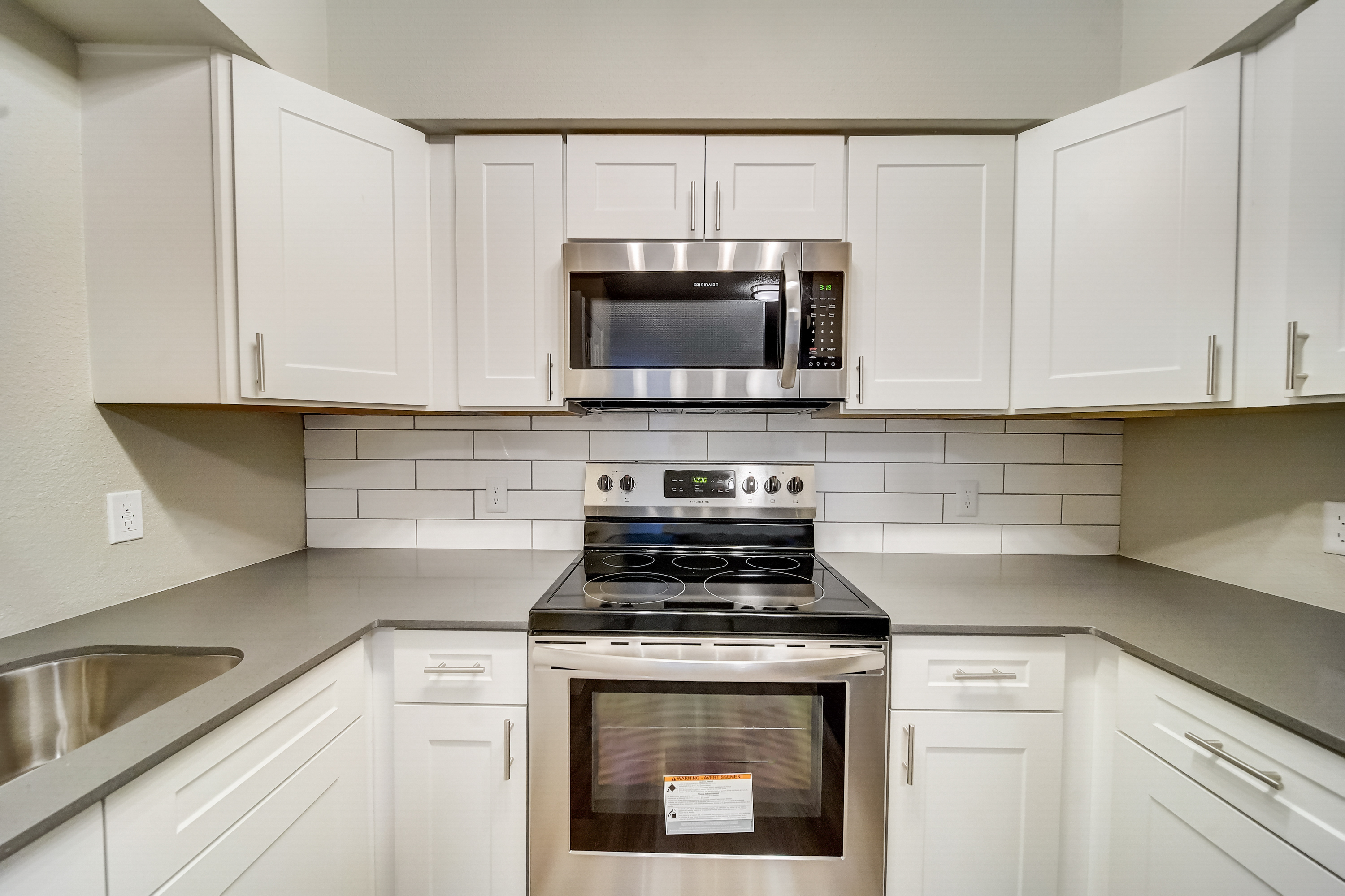 a stove top oven sitting inside of a kitchen