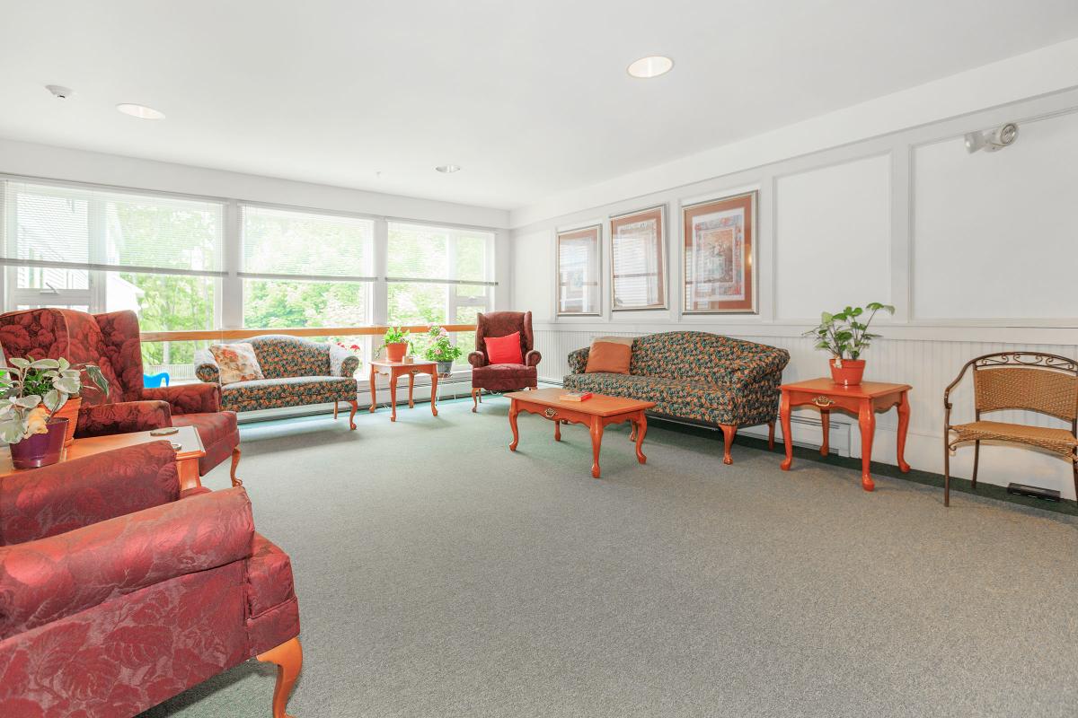 a living room filled with furniture and a large window