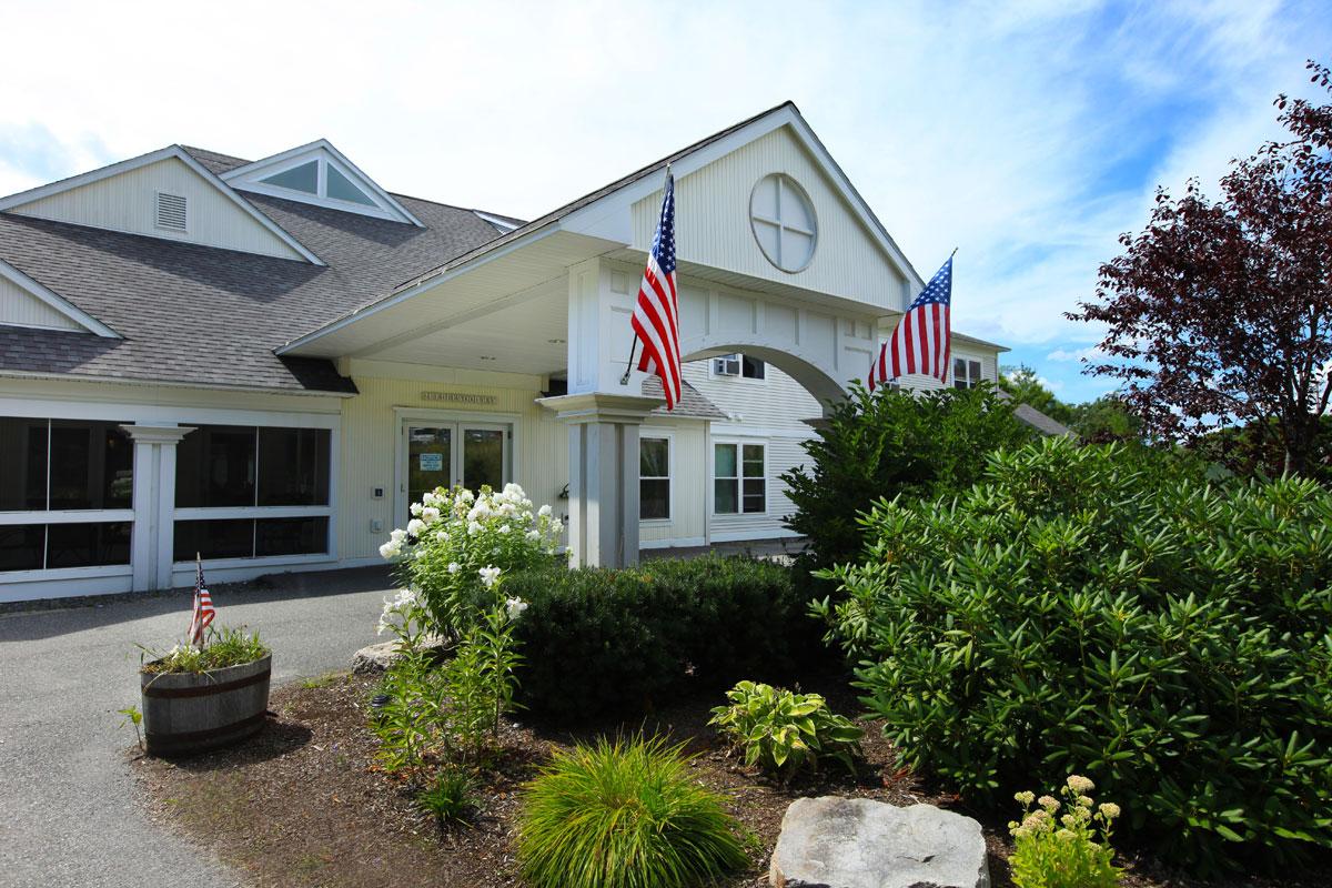 a house with bushes in front of a building