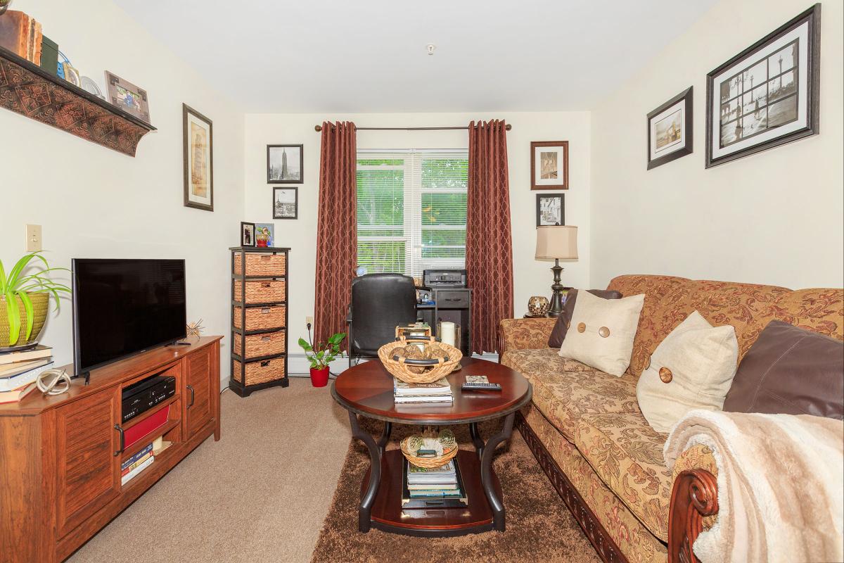 a living room filled with furniture and a flat screen tv