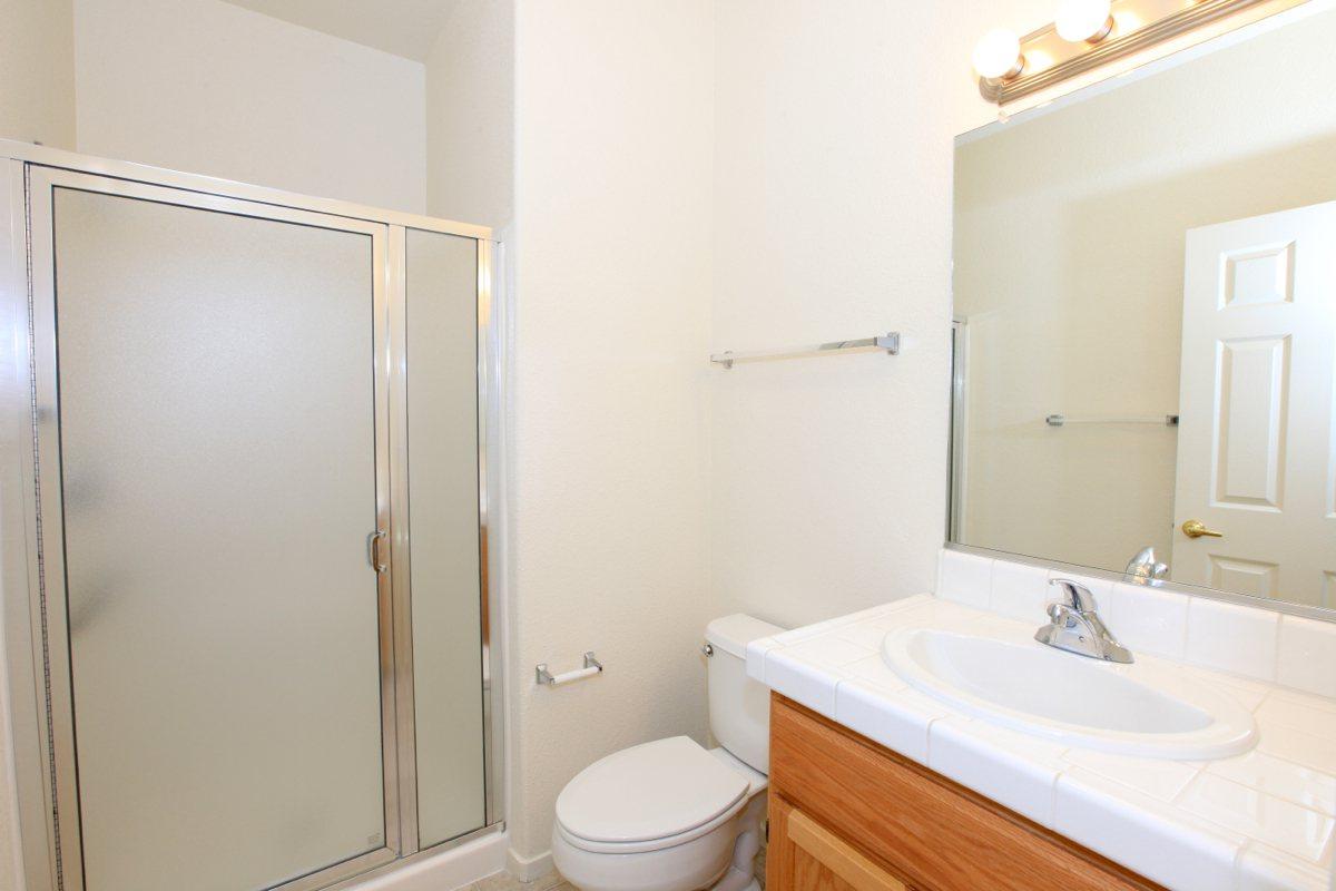 a white sink sitting next to a glass shower door