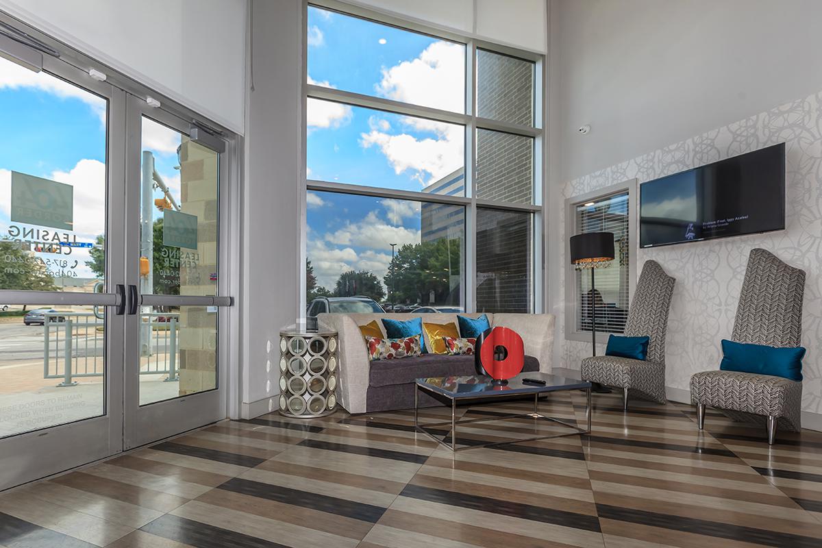 a living room filled with furniture and a large window