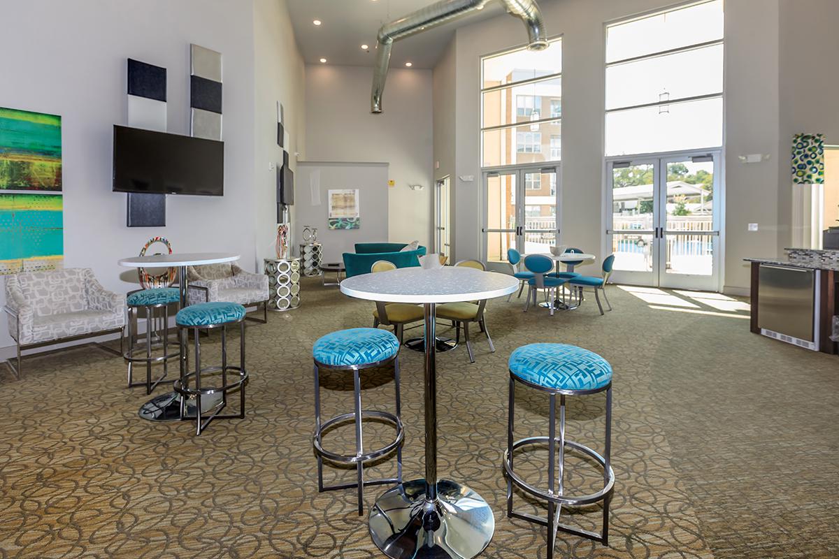 a living room filled with furniture and a blue chair