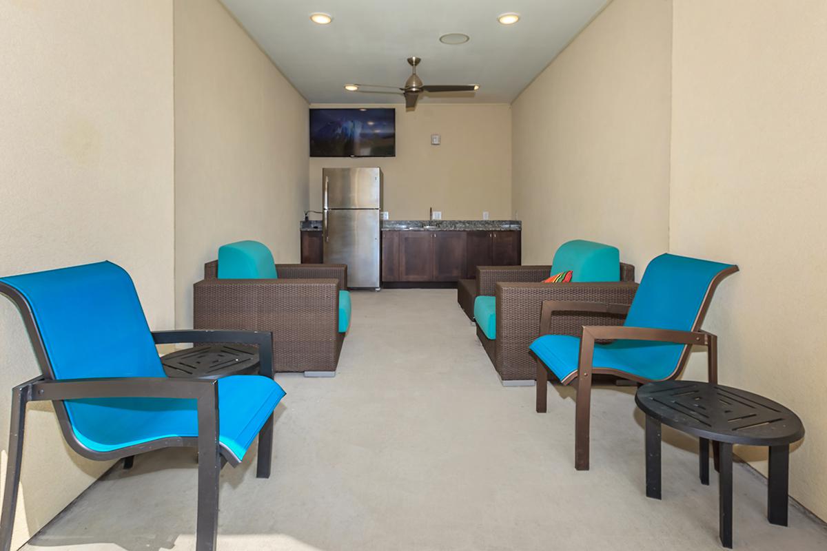 a living room filled with furniture and a blue chair