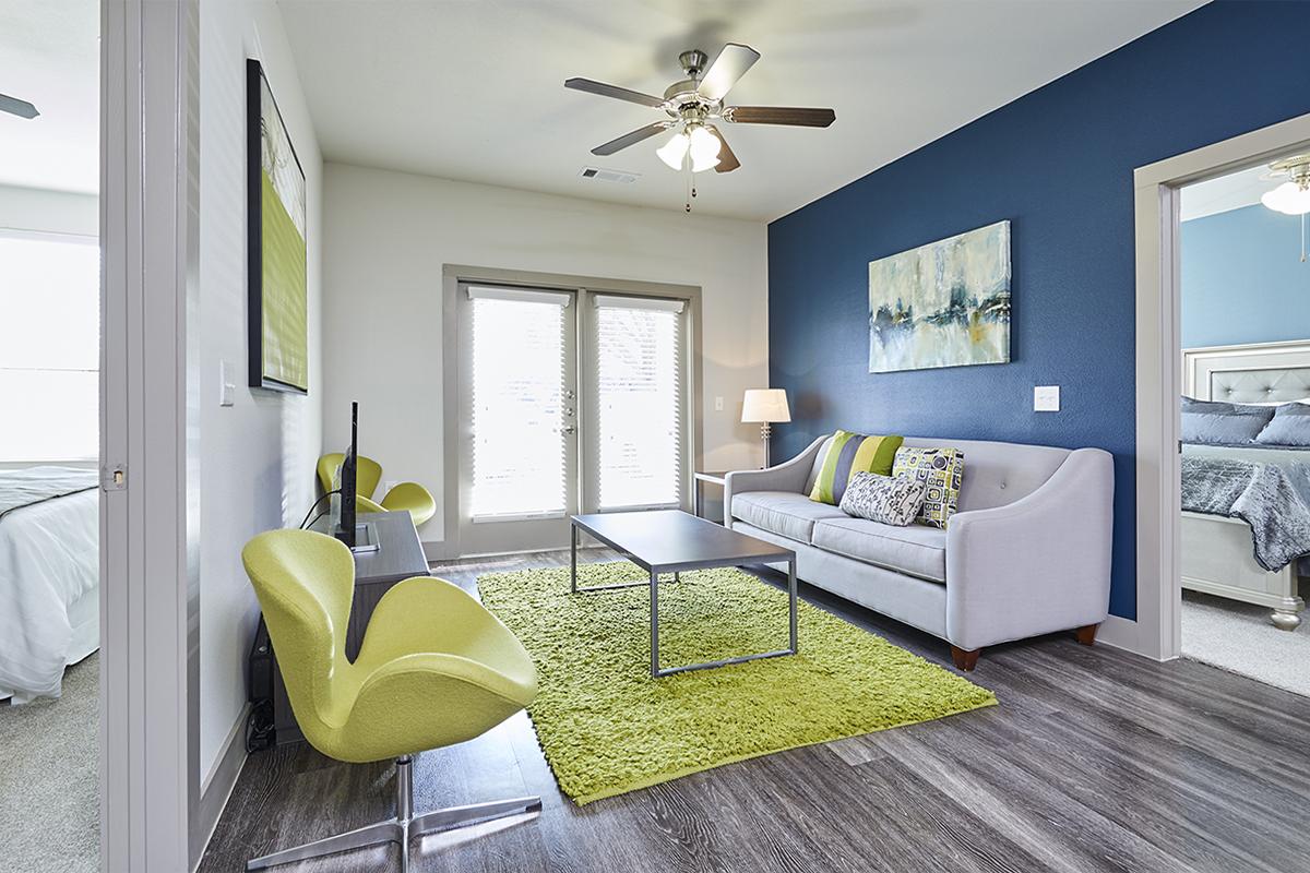 a living room filled with furniture and a large window