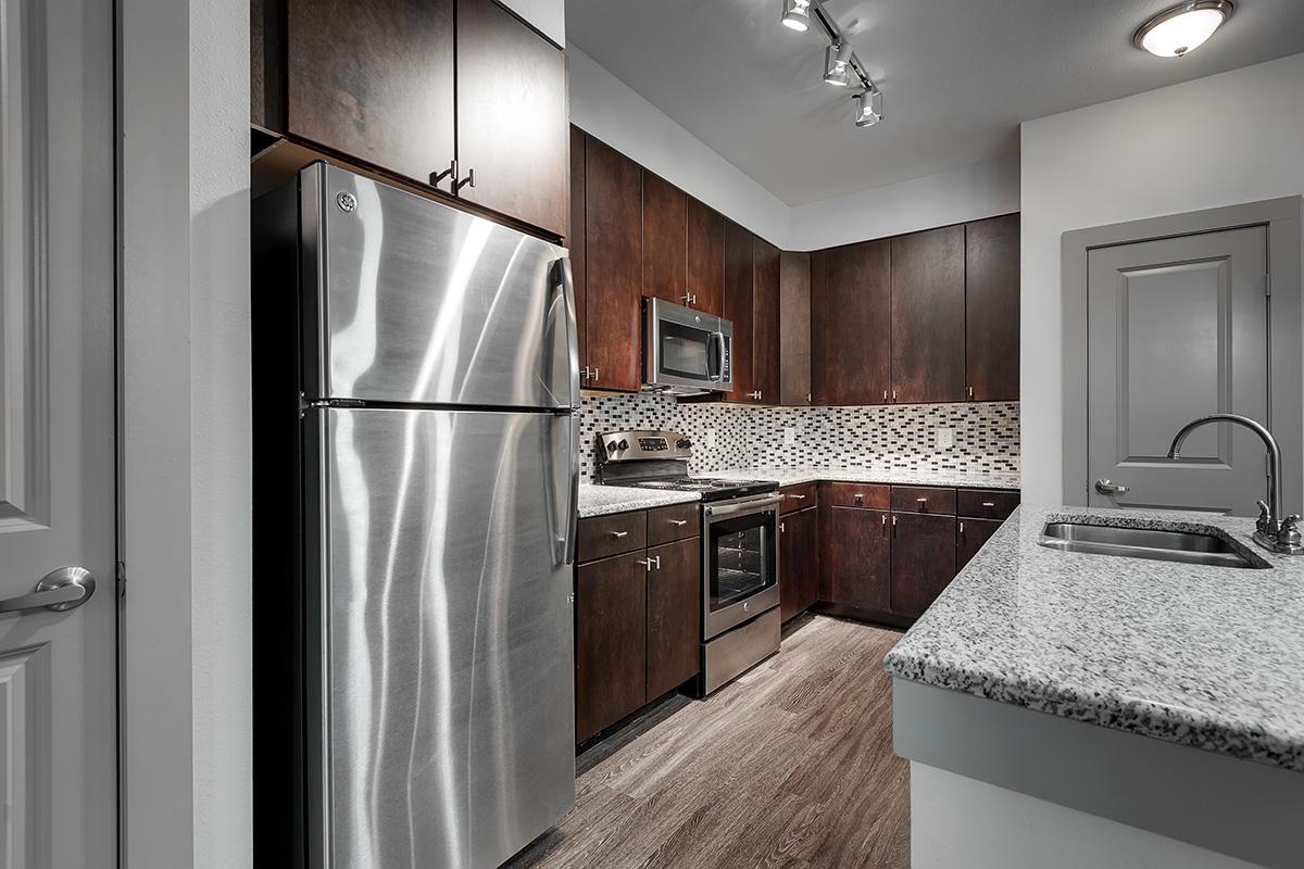 a kitchen with a sink and a refrigerator