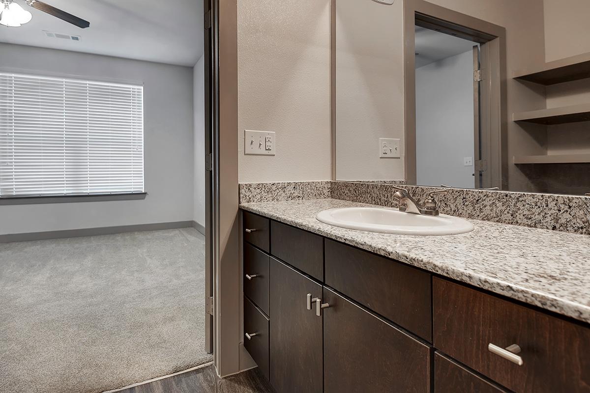 a kitchen with a sink and a mirror