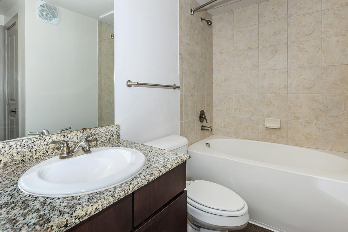 a large white tub next to a sink